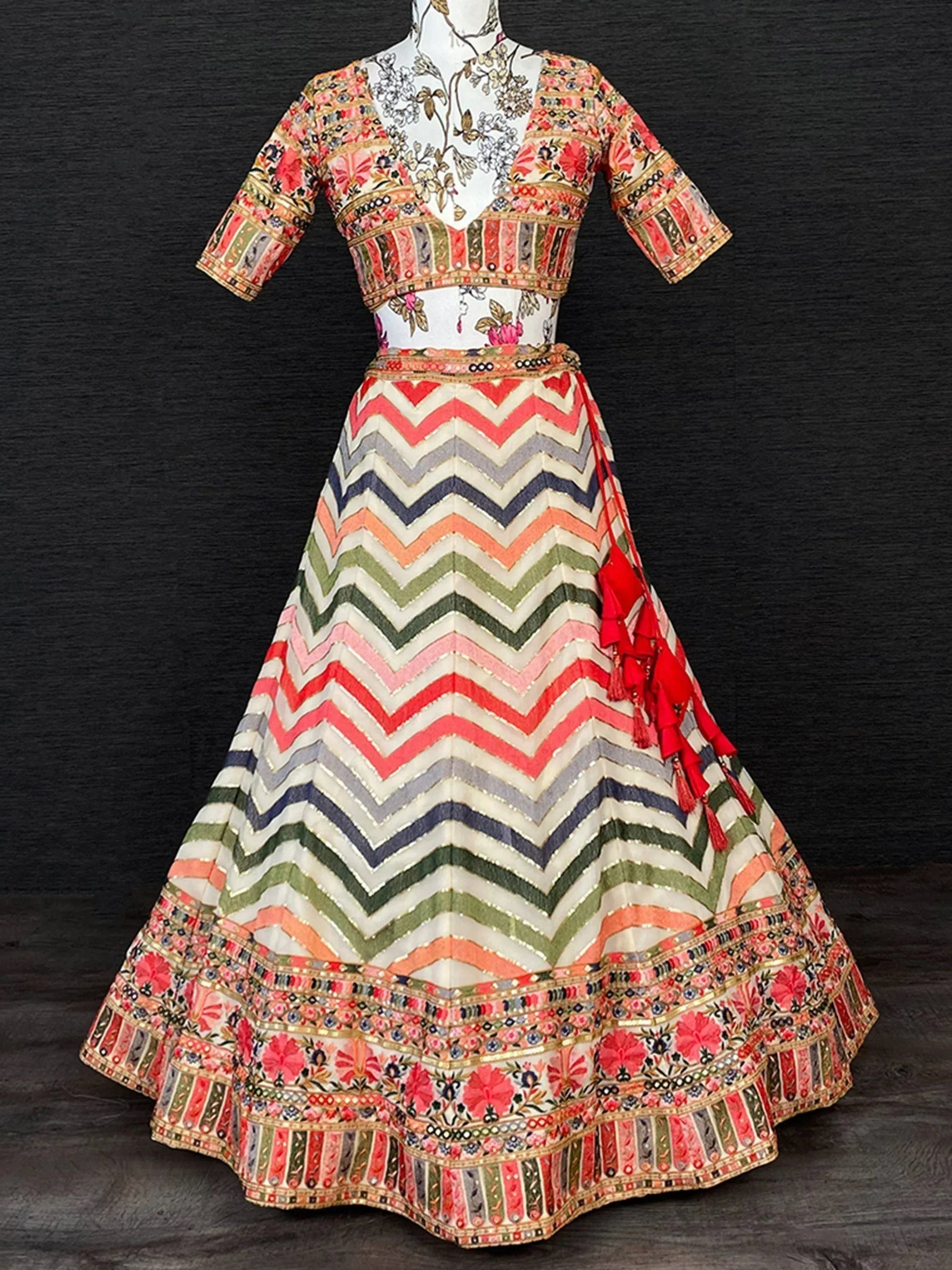 Colorful Indian lehenga choli with floral top and chevron skirt, perfect for ethnic wear occasions
