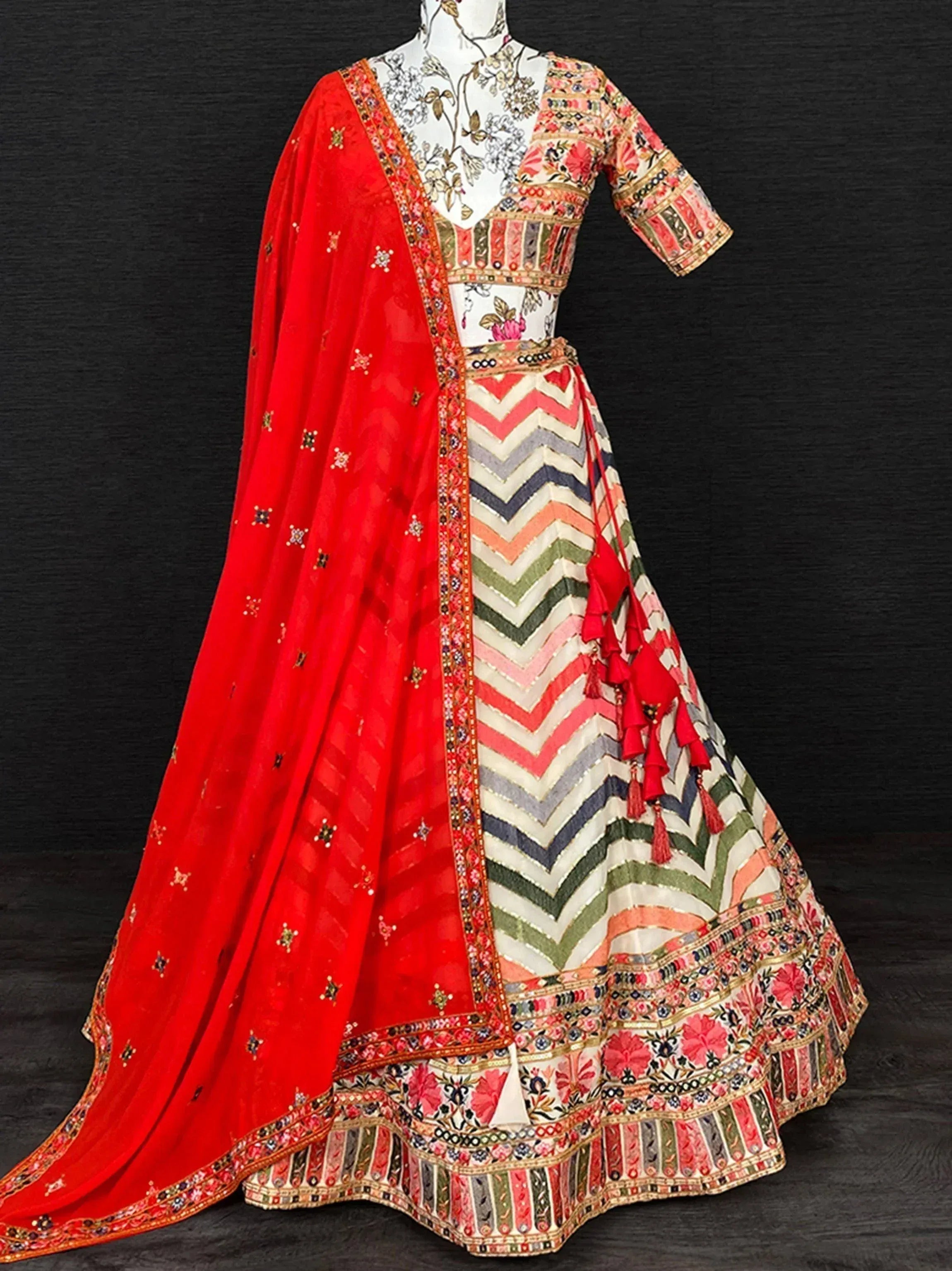 Colorful Indian lehenga choli with red dupatta, floral and chevron print, perfect for weddings and festivals