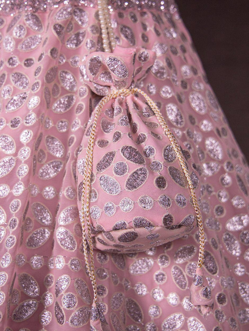 Pink ethnic lehenga with silver leaf embroidery and matching potli bag, perfect for Indian weddings and festive occasions
