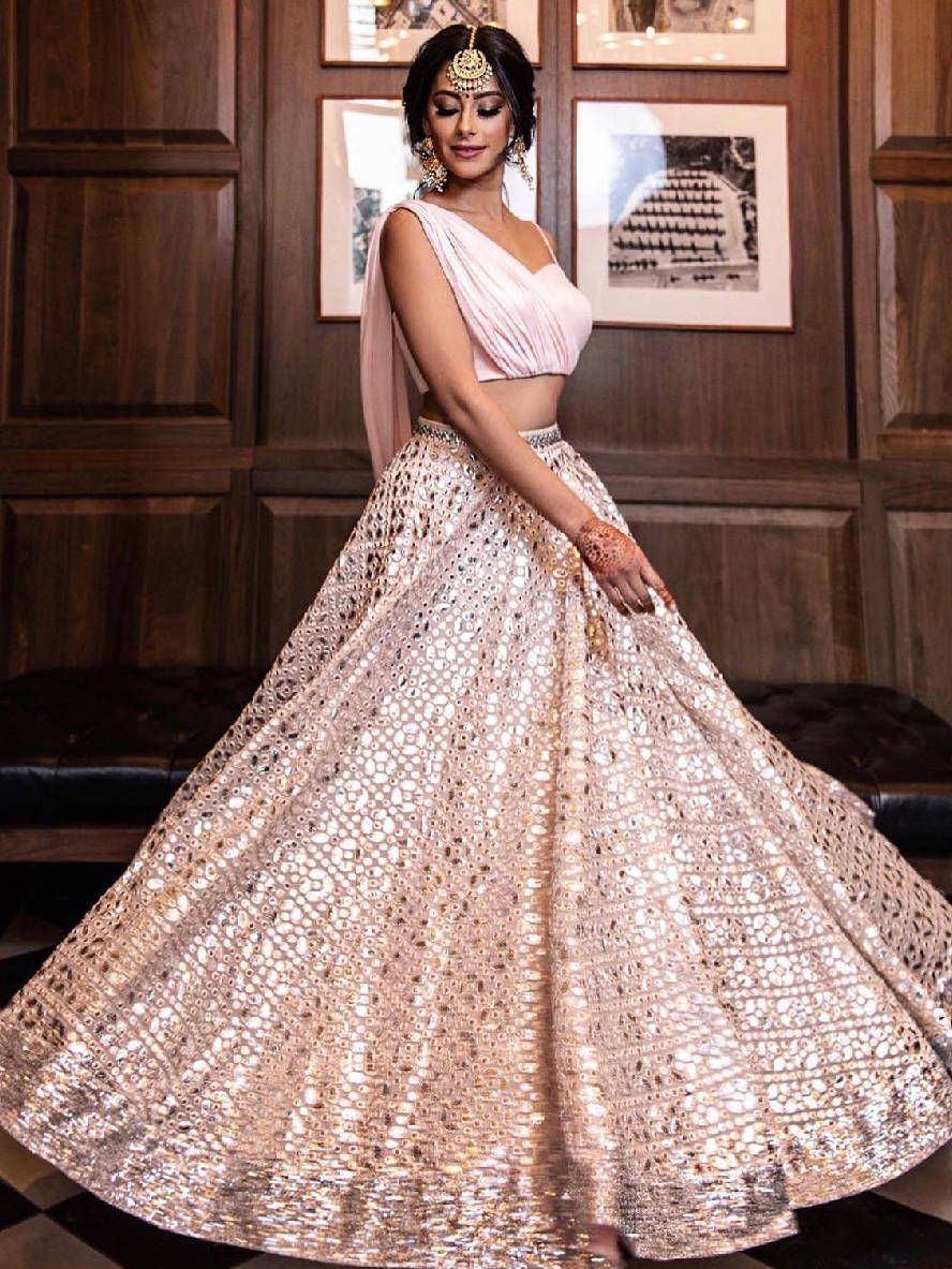 Elegant pink lehenga choli with mirror work skirt, perfect for Indian weddings and festive occasions.