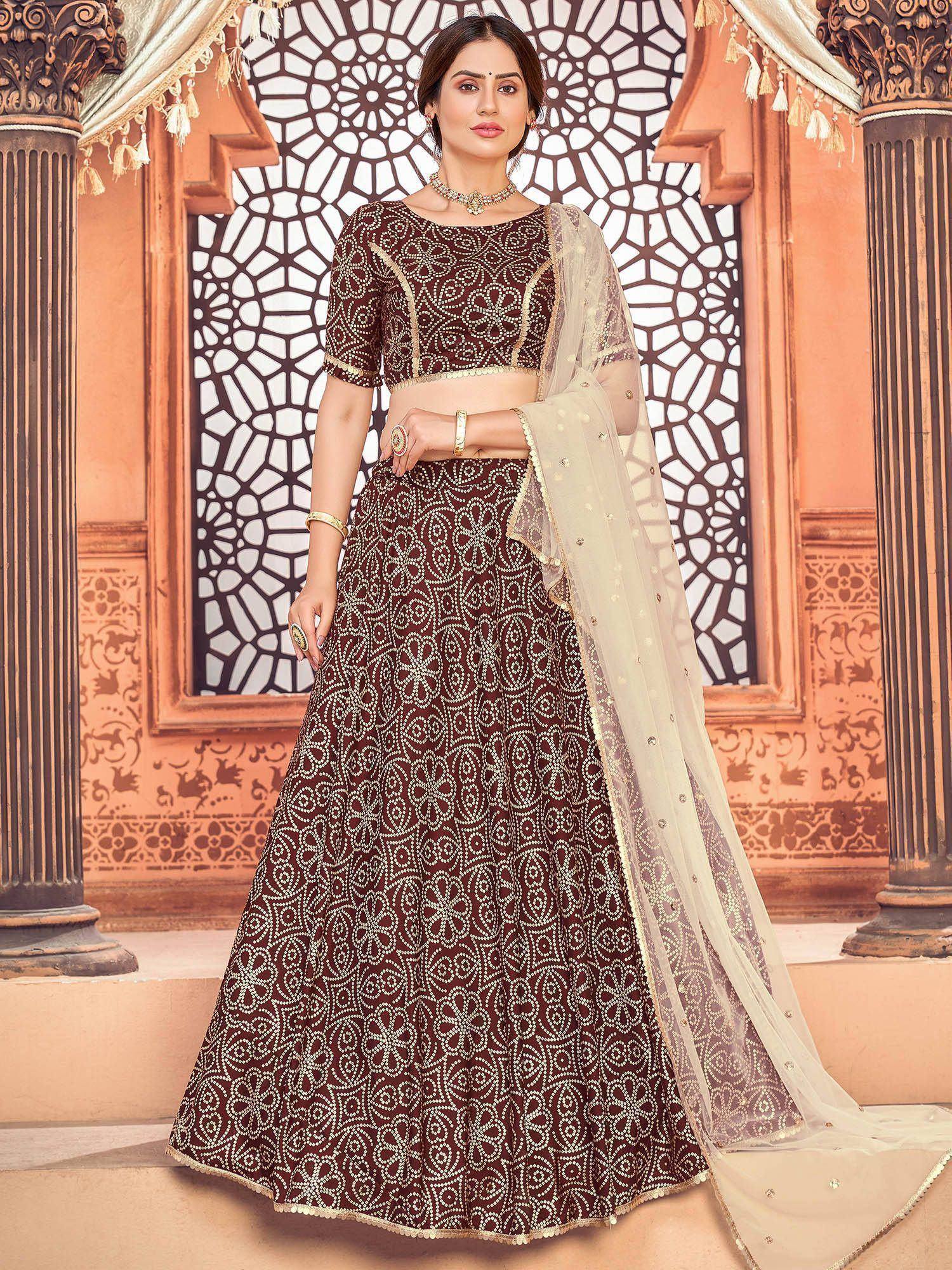 Maroon designer lehenga choli with gold embroidery and sheer dupatta, perfect for Indian weddings and festive occasions.