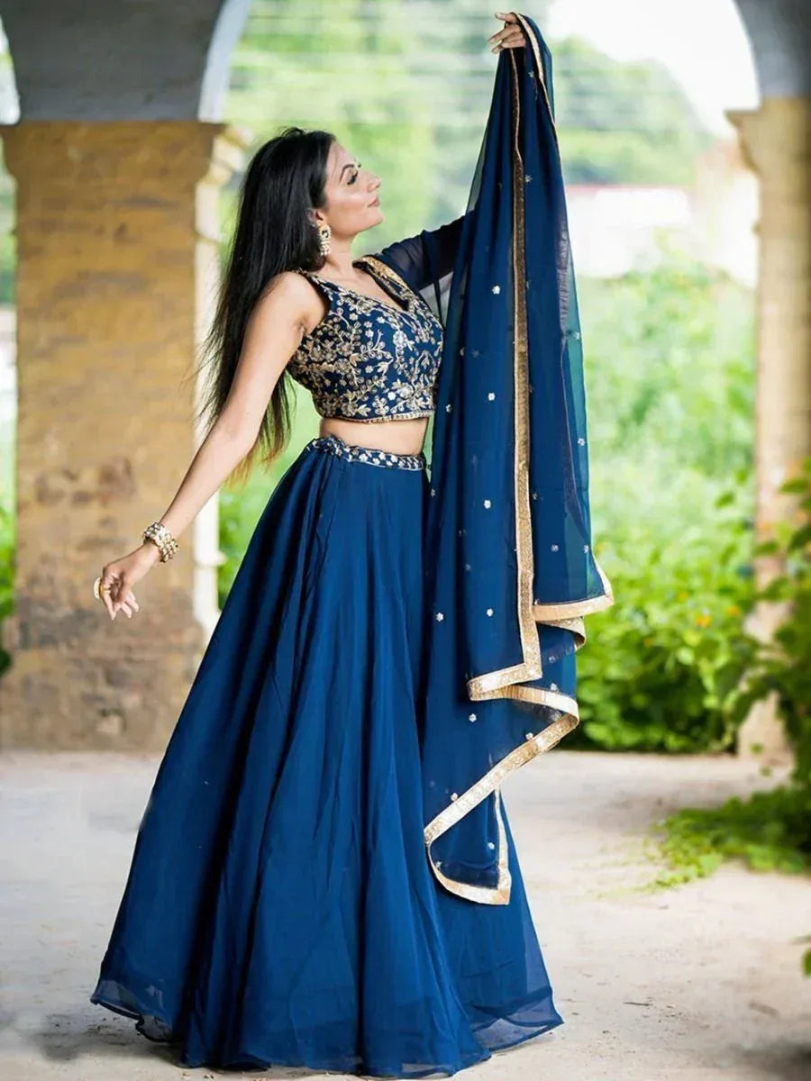 Blue embroidered lehenga choli with gold detailing and matching dupatta, perfect for Indian ethnic wear occasions