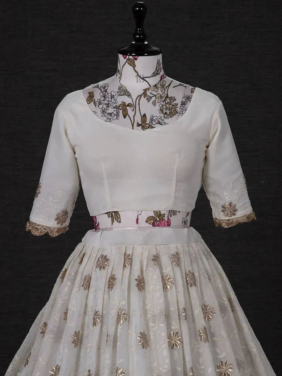 White floral embroidered lehenga choli with gold accents, perfect for Indian ethnic wear occasions