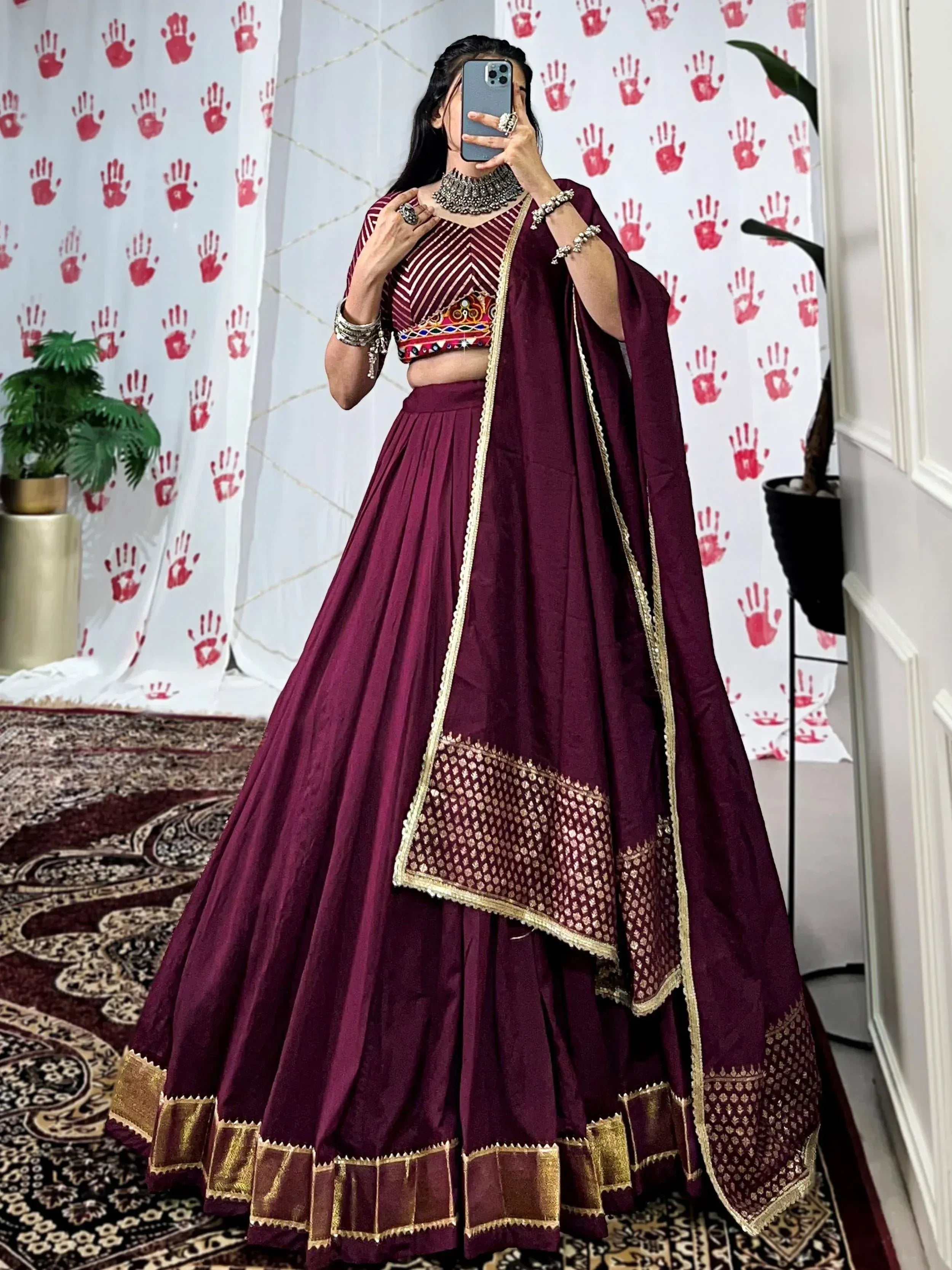 Burgundy lehenga choli with gold embroidery, mirror work blouse, and dupatta for Indian ethnic wear