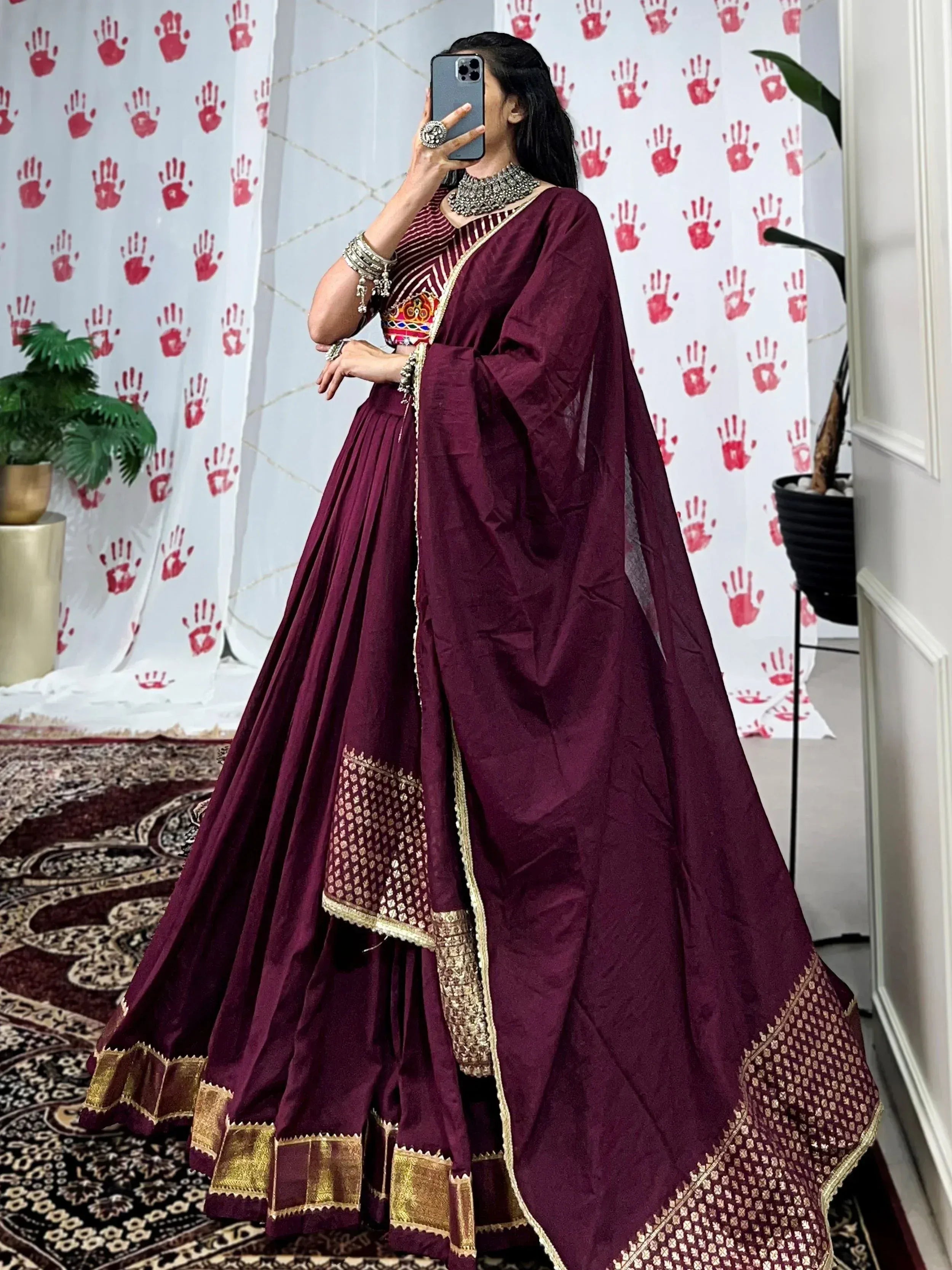 Maroon designer lehenga choli with gold embroidery, perfect for Indian ethnic wear and festive occasions.