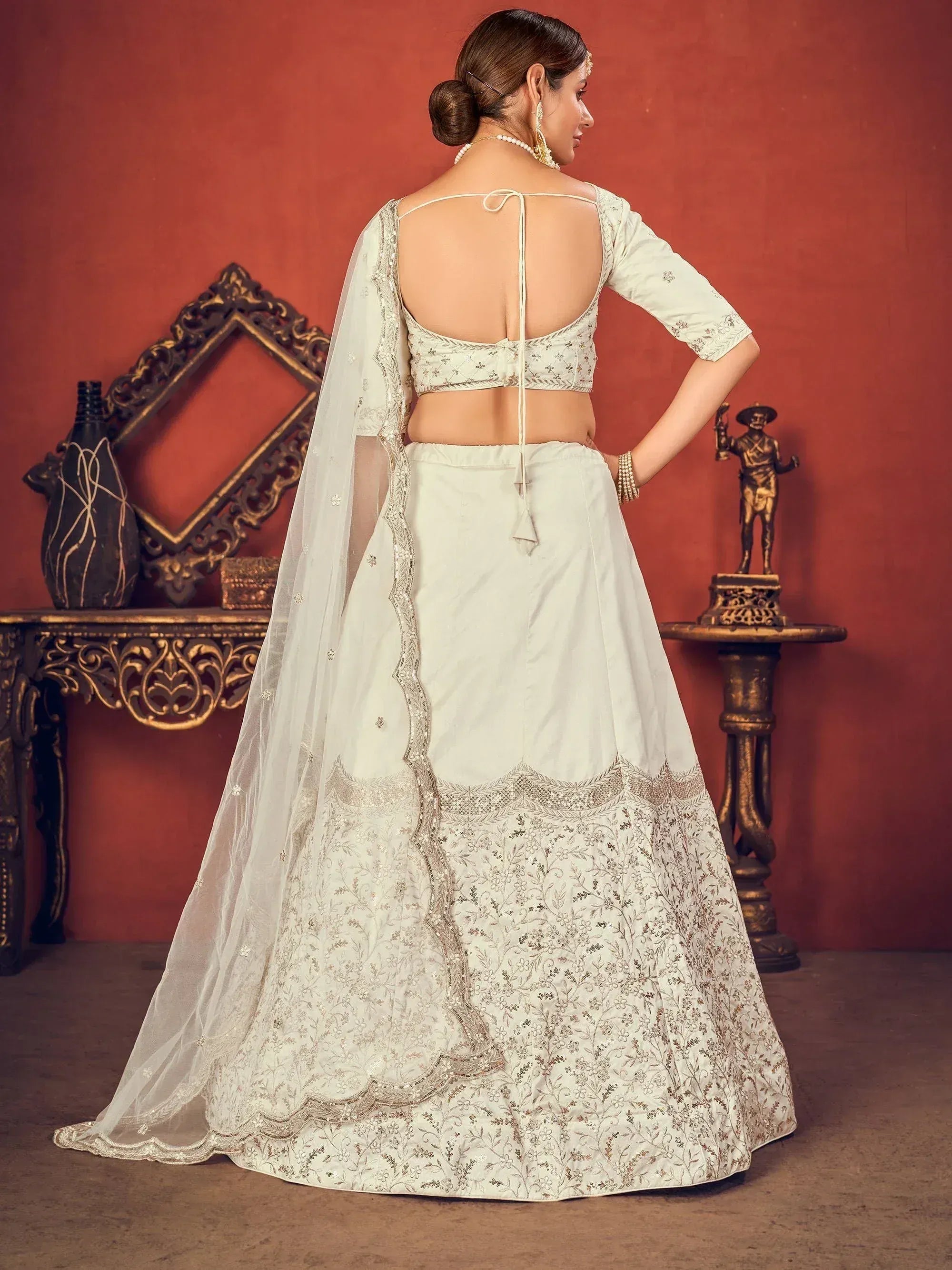 Elegant off-white lehenga choli with floral embroidery, sheer dupatta, and open back blouse for Indian ethnic wear