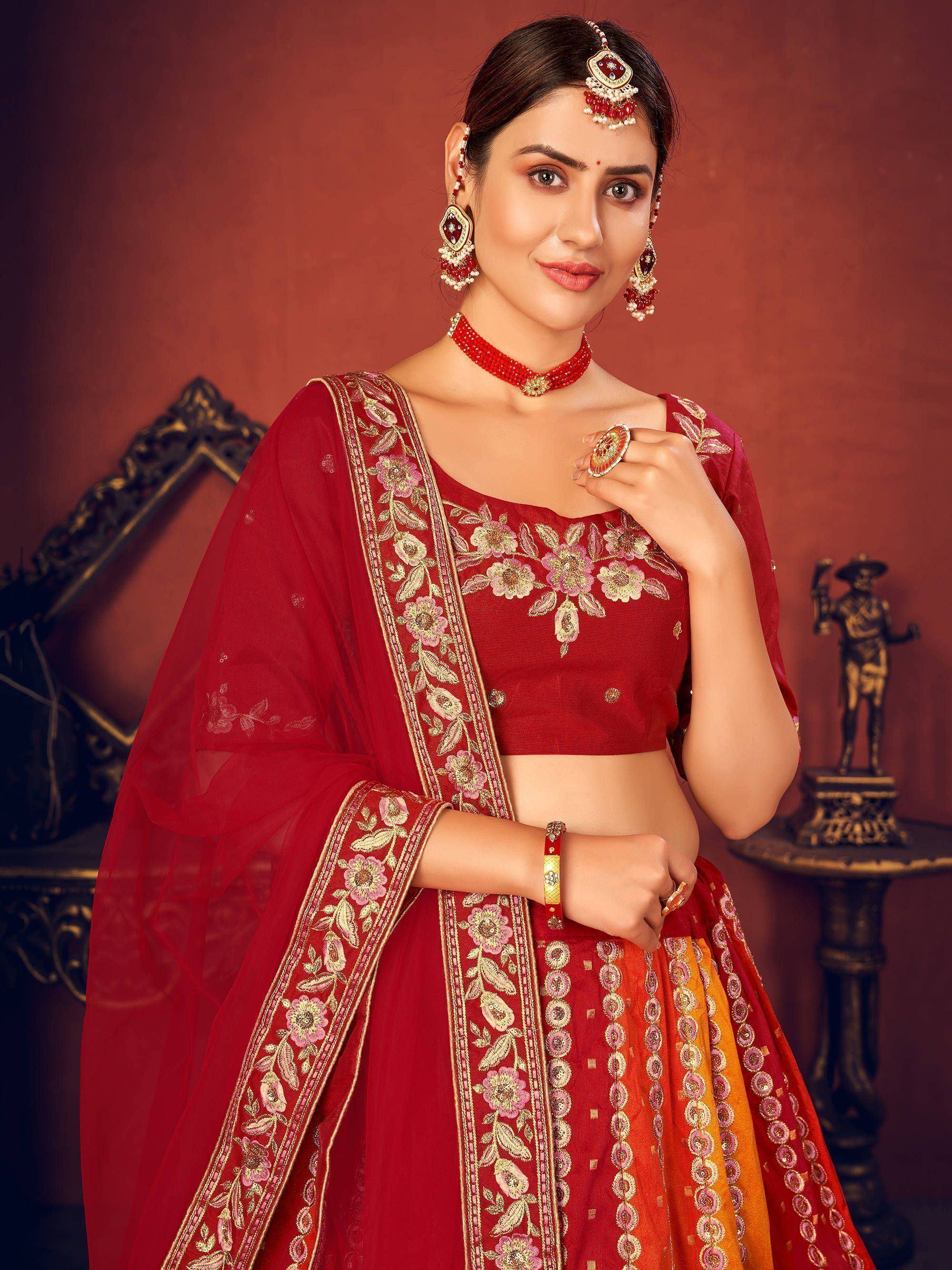 Red embroidered lehenga choli with floral detailing, perfect for Indian weddings and festive occasions.