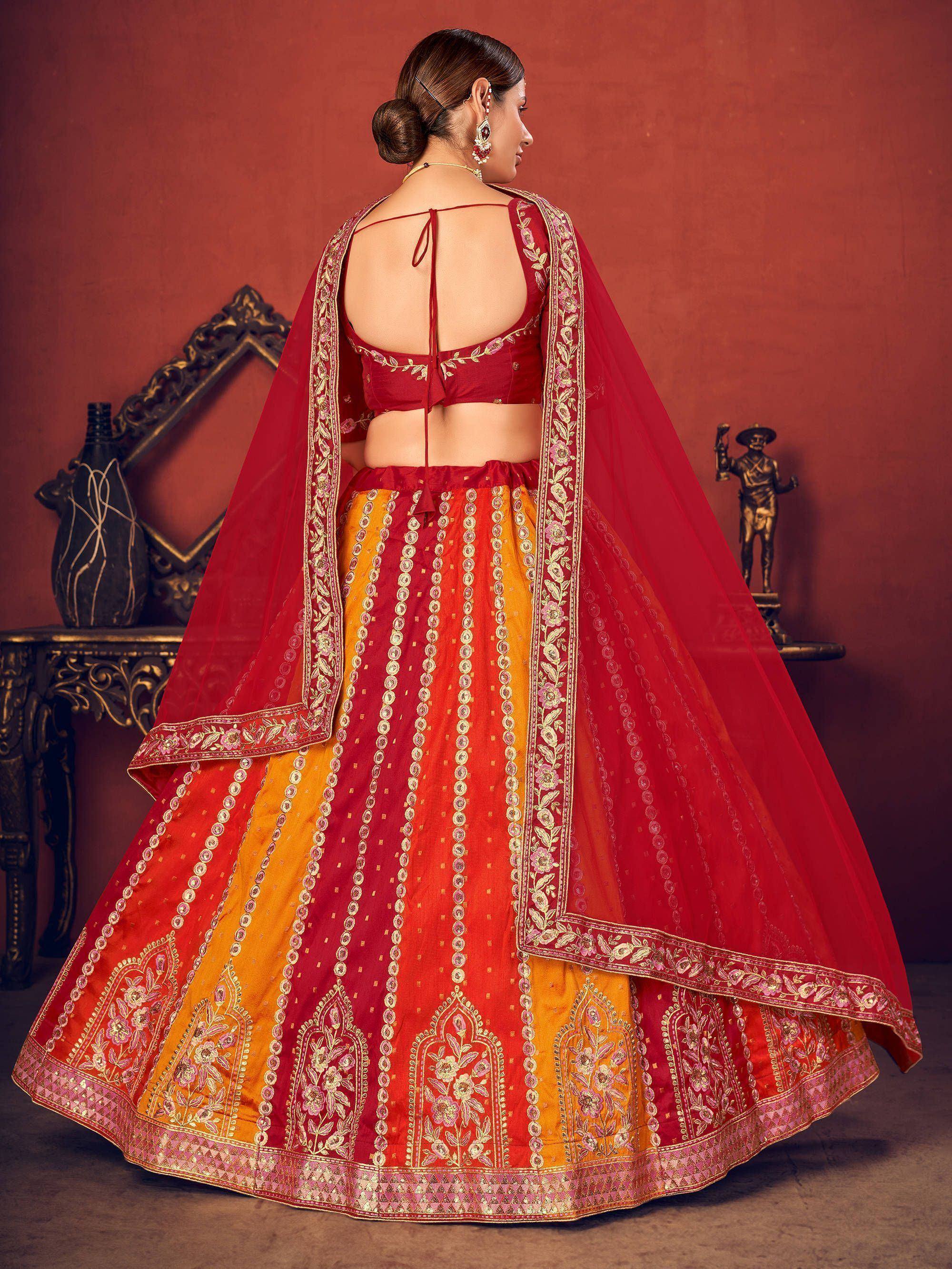 Red and orange embroidered lehenga choli with floral dupatta, back view