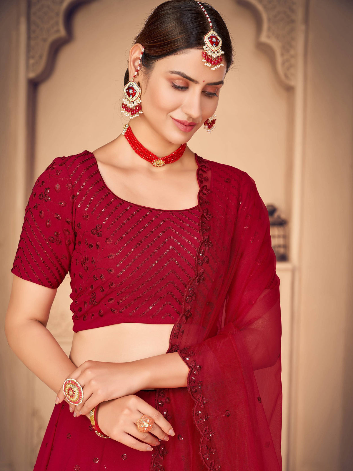 Red sequin lehenga choli with matching jewelry, ethnic Indian wear for weddings