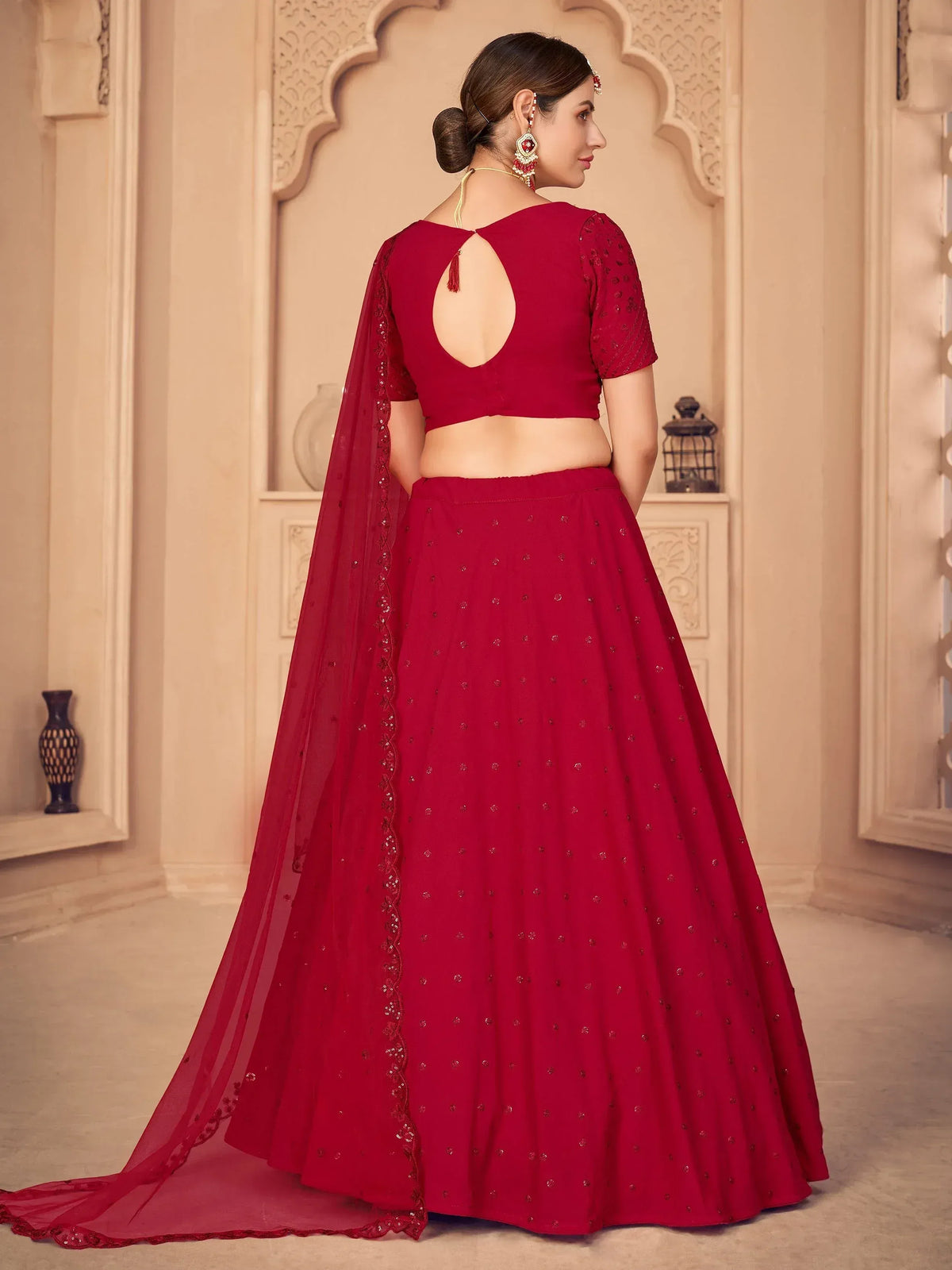 Red designer lehenga choli with back cutout and sequin detailing, perfect for Indian ethnic wear