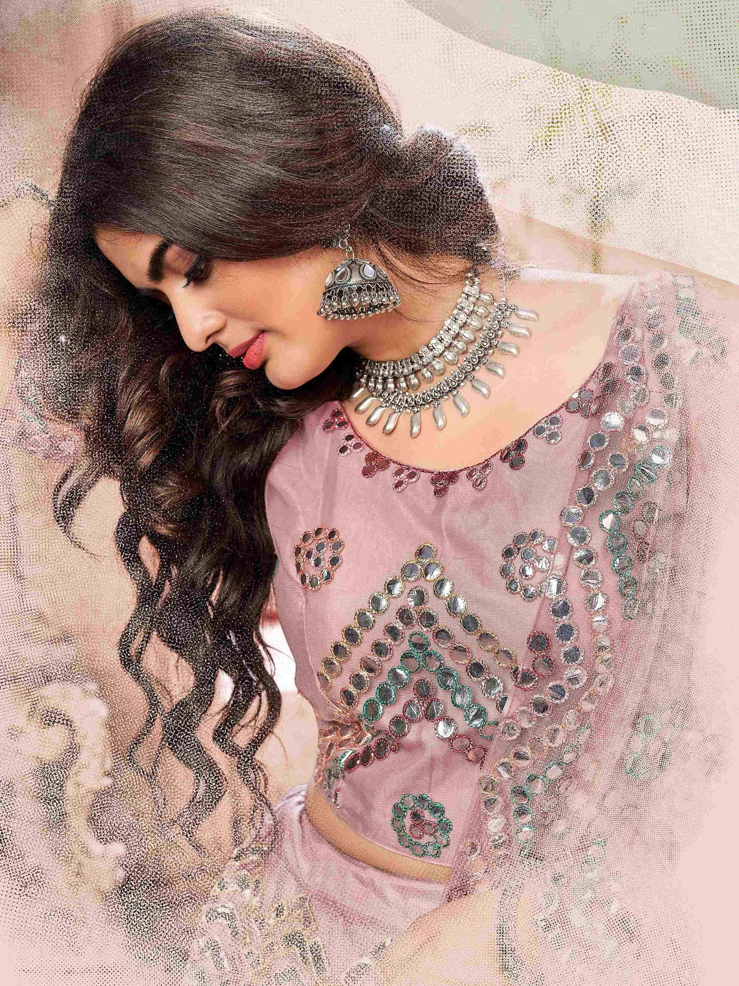 Pink ethnic blouse with mirror work, paired with traditional jewelry for Indian wear