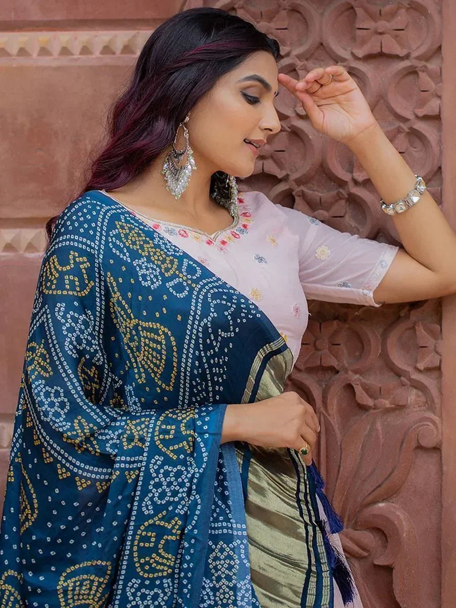 Woman in blue printed saree with floral blouse, ethnic Indian wear for festive occasions