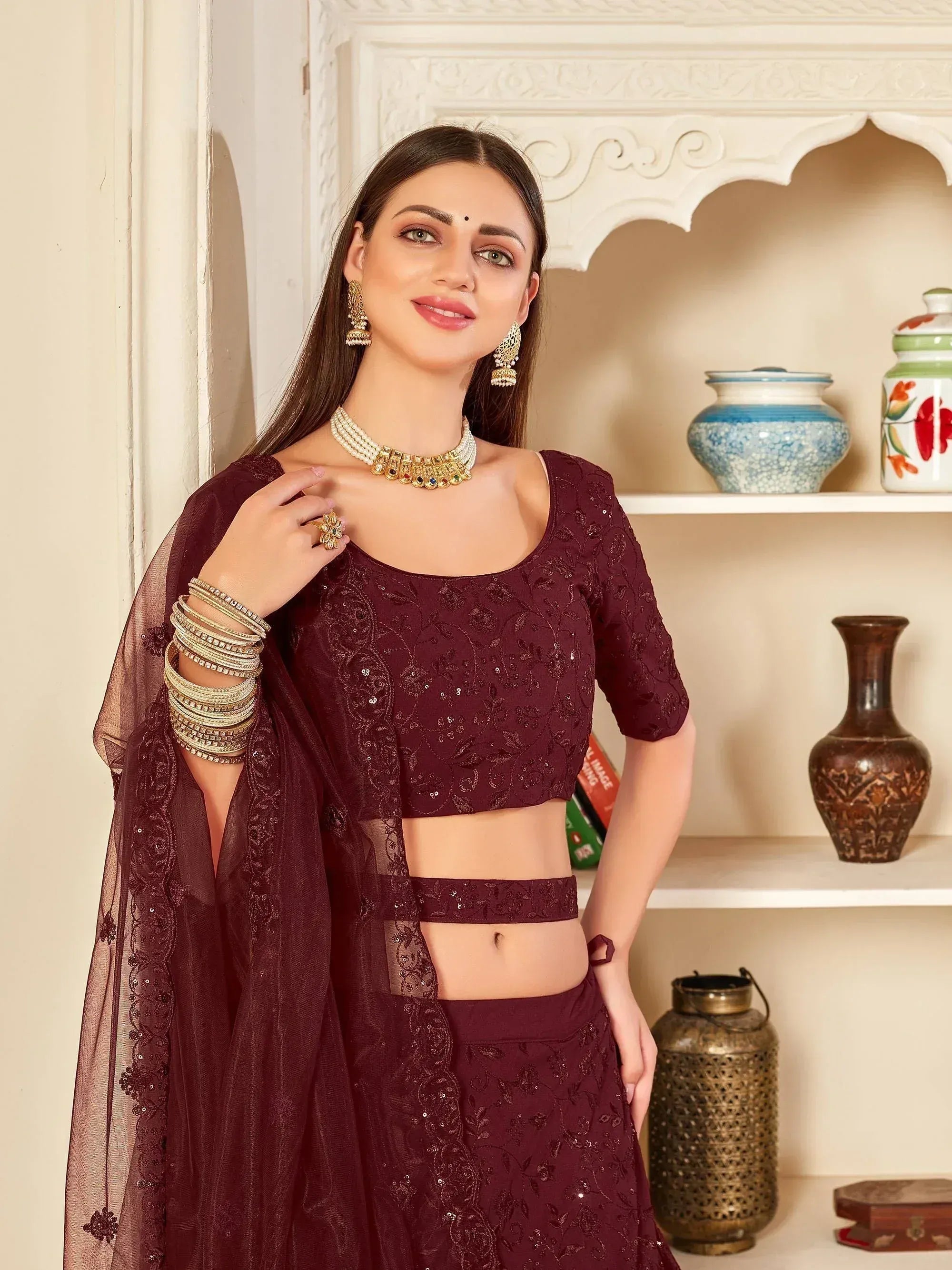 Elegant maroon designer lehenga choli with sequin embroidery, perfect for Indian ethnic wear occasions.