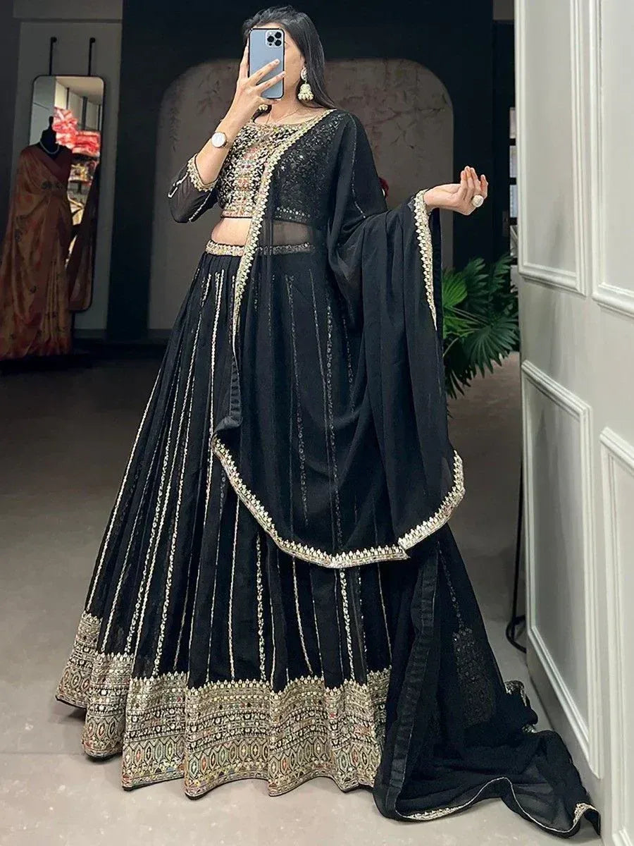 Black embroidered lehenga choli with gold detailing, perfect for Indian ethnic wear and festive occasions.