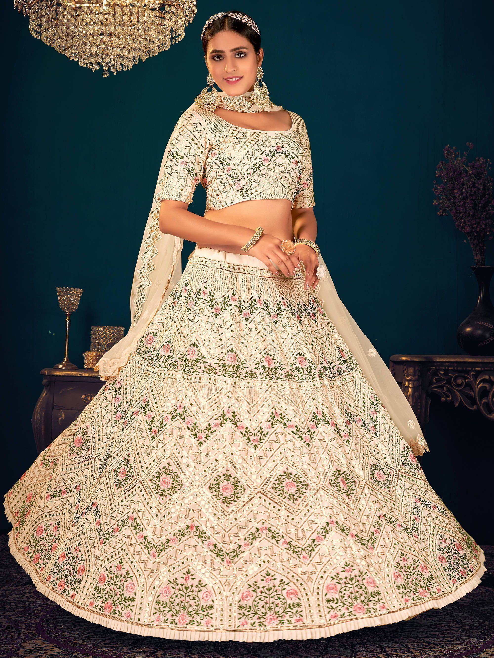 Elegant ivory lehenga choli with floral embroidery and mirror work, perfect for Indian weddings and festive occasions.