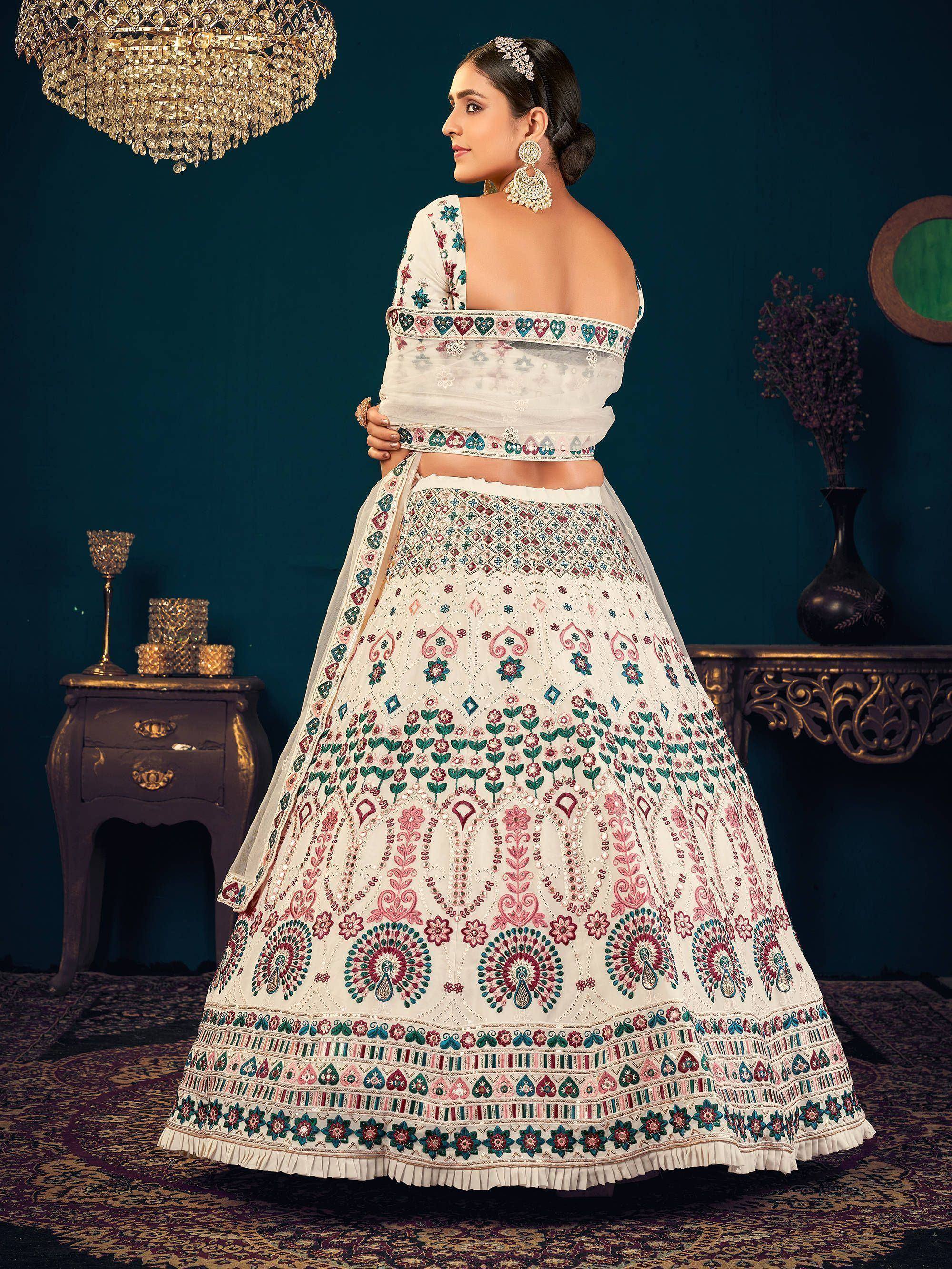 White embroidered lehenga choli with floral motifs, perfect for Indian weddings and festive occasions.