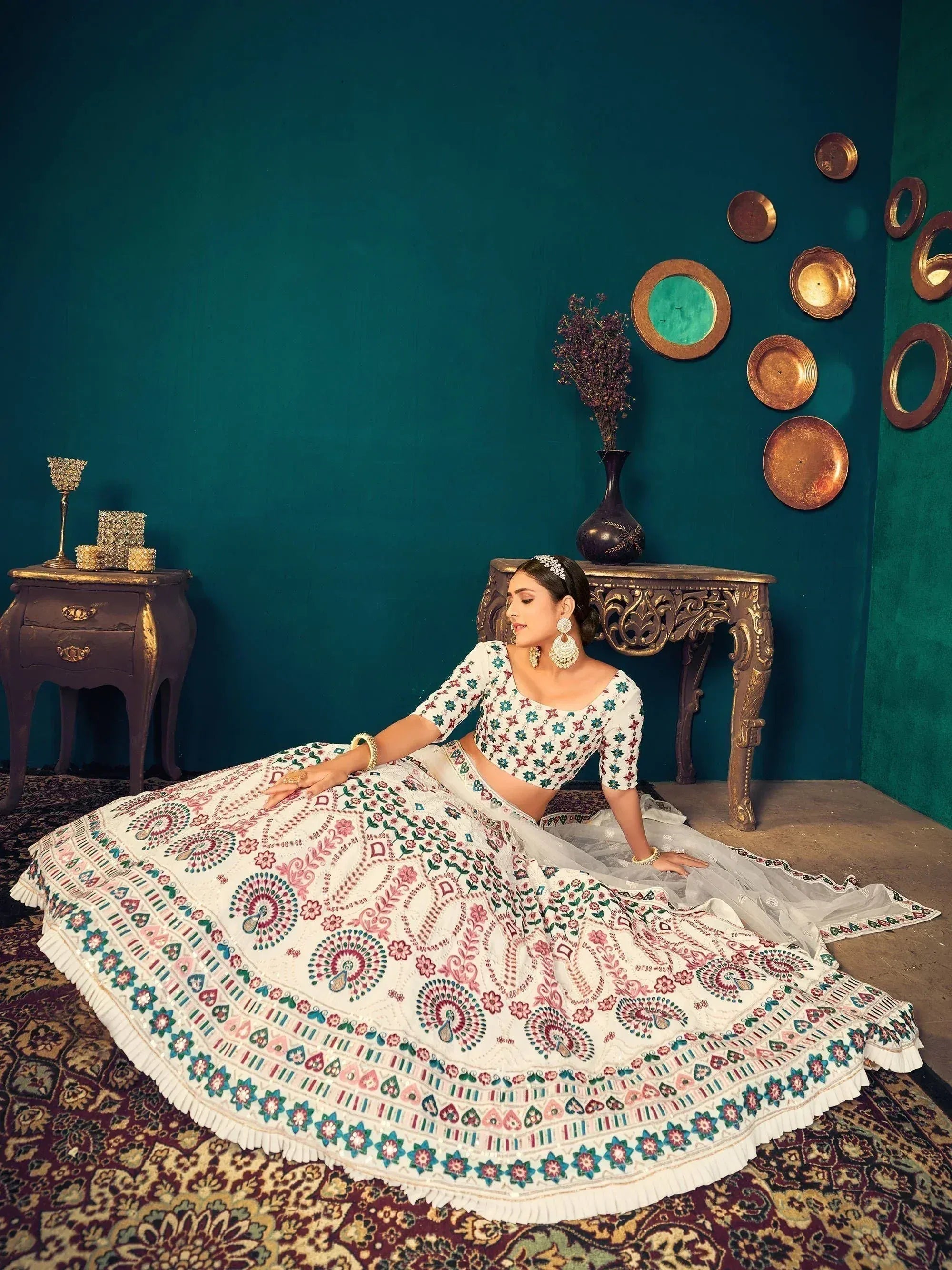 Elegant white lehenga choli with colorful floral embroidery, perfect for Indian ethnic wear events