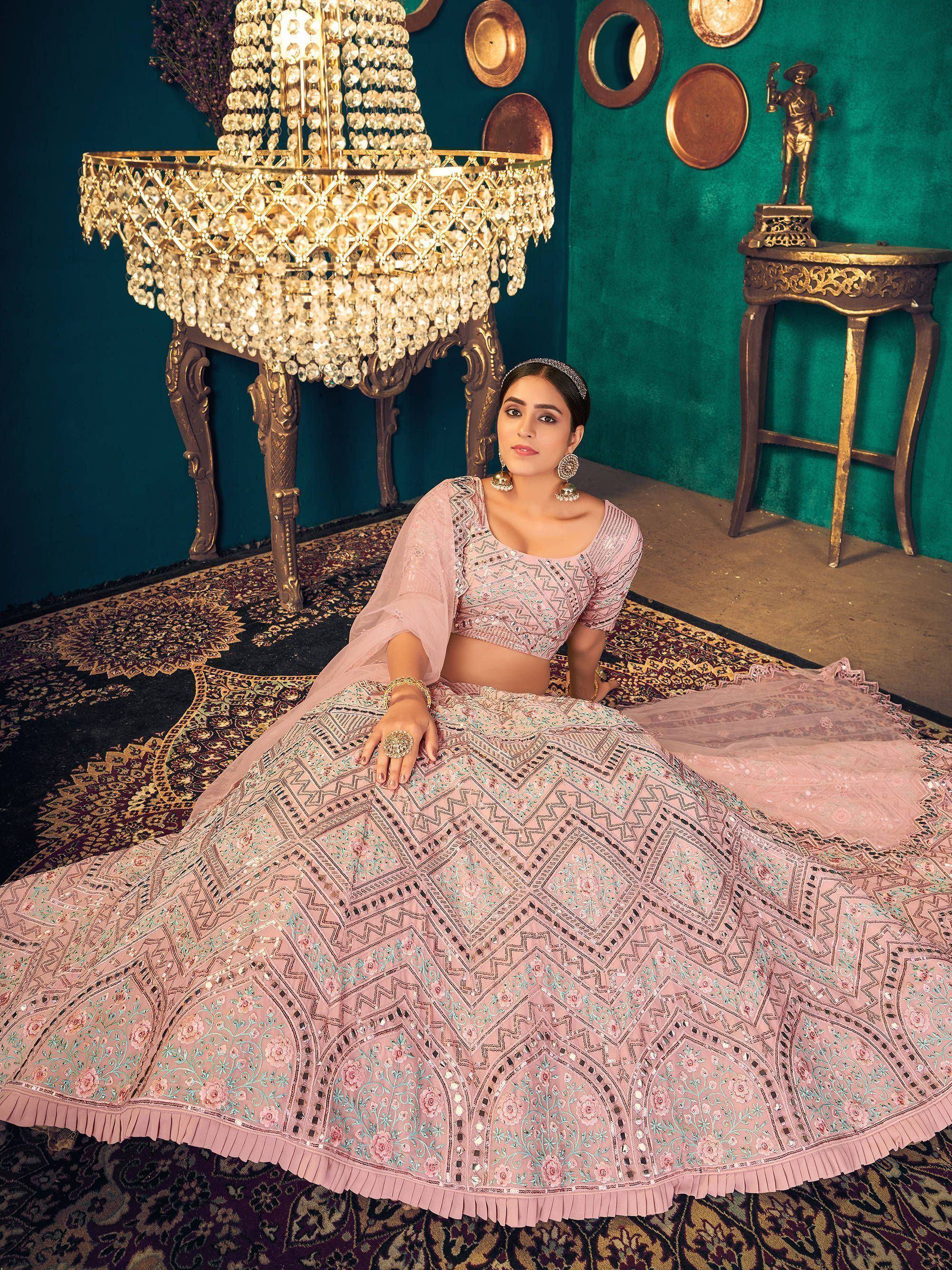 Elegant pink embroidered lehenga choli with geometric patterns, perfect for Indian ethnic wear.