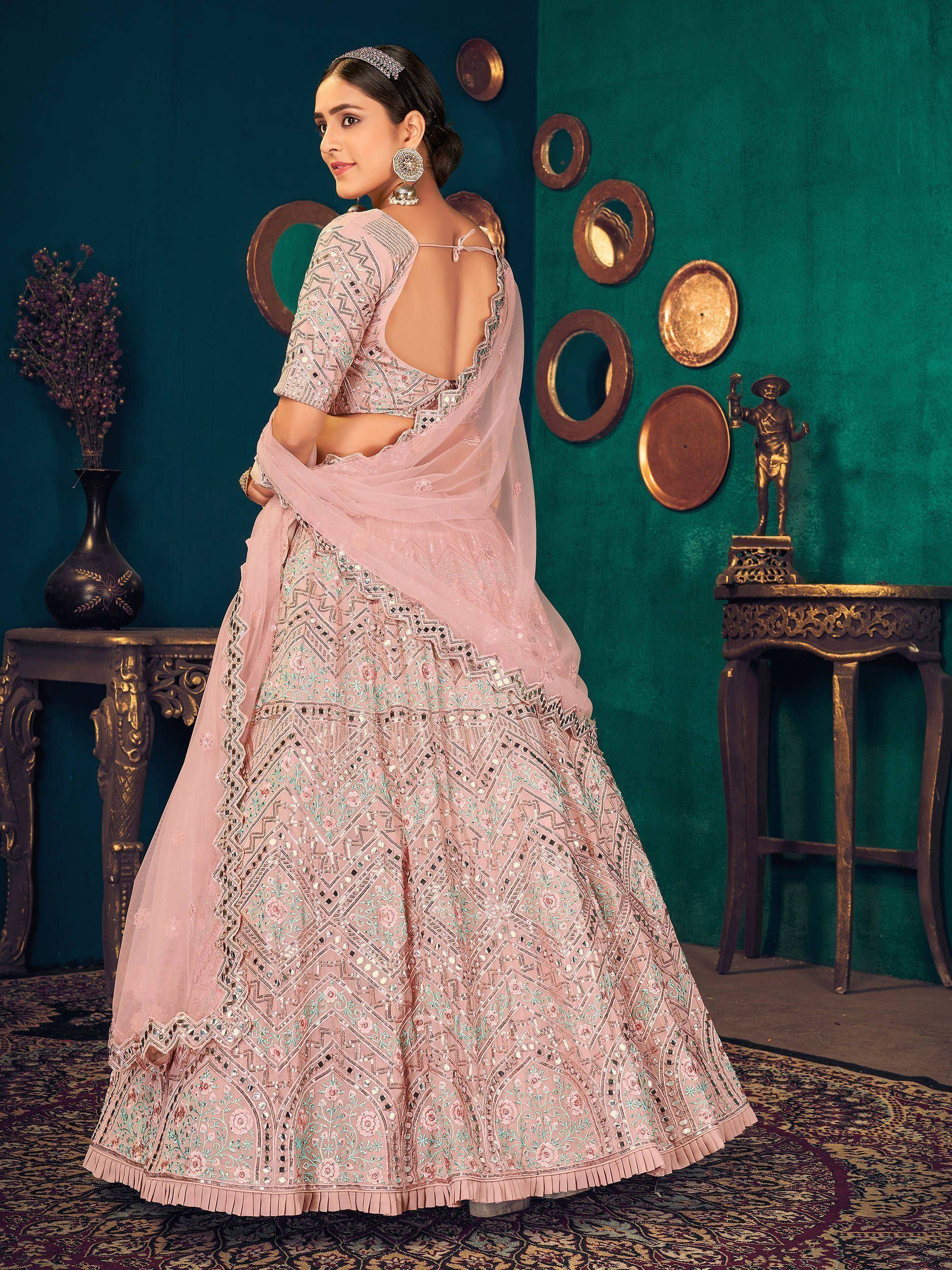 Elegant pink designer lehenga choli with intricate embroidery and mirror work, perfect for Indian ethnic wear.