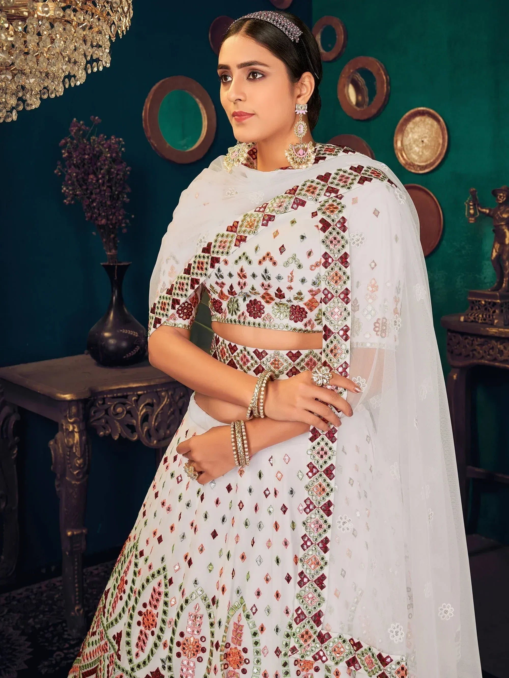 White embroidered lehenga choli with mirror work, perfect for Indian ethnic wear and festive occasions.