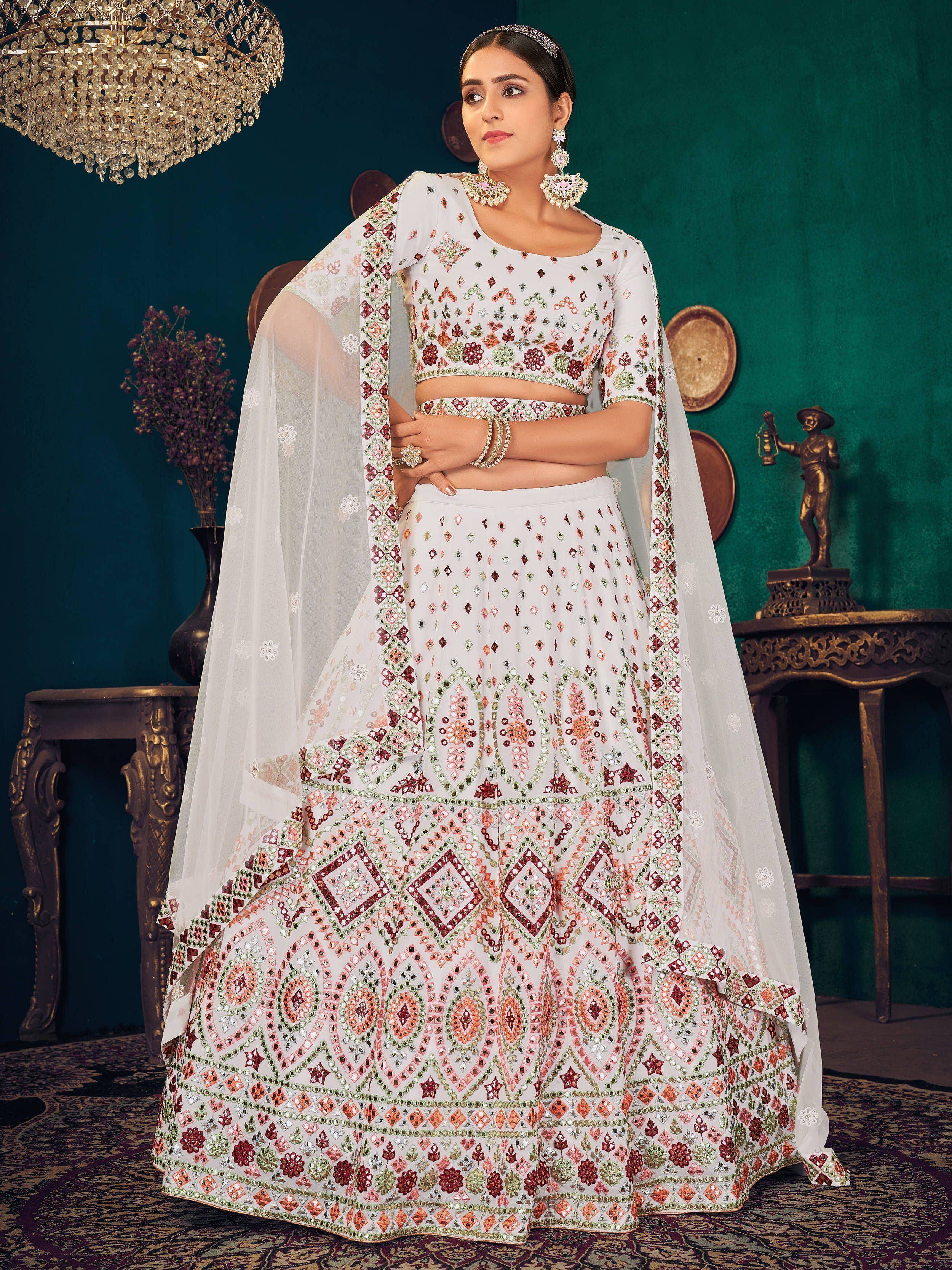 White designer lehenga choli with mirror work and floral embroidery, perfect for Indian ethnic occasions