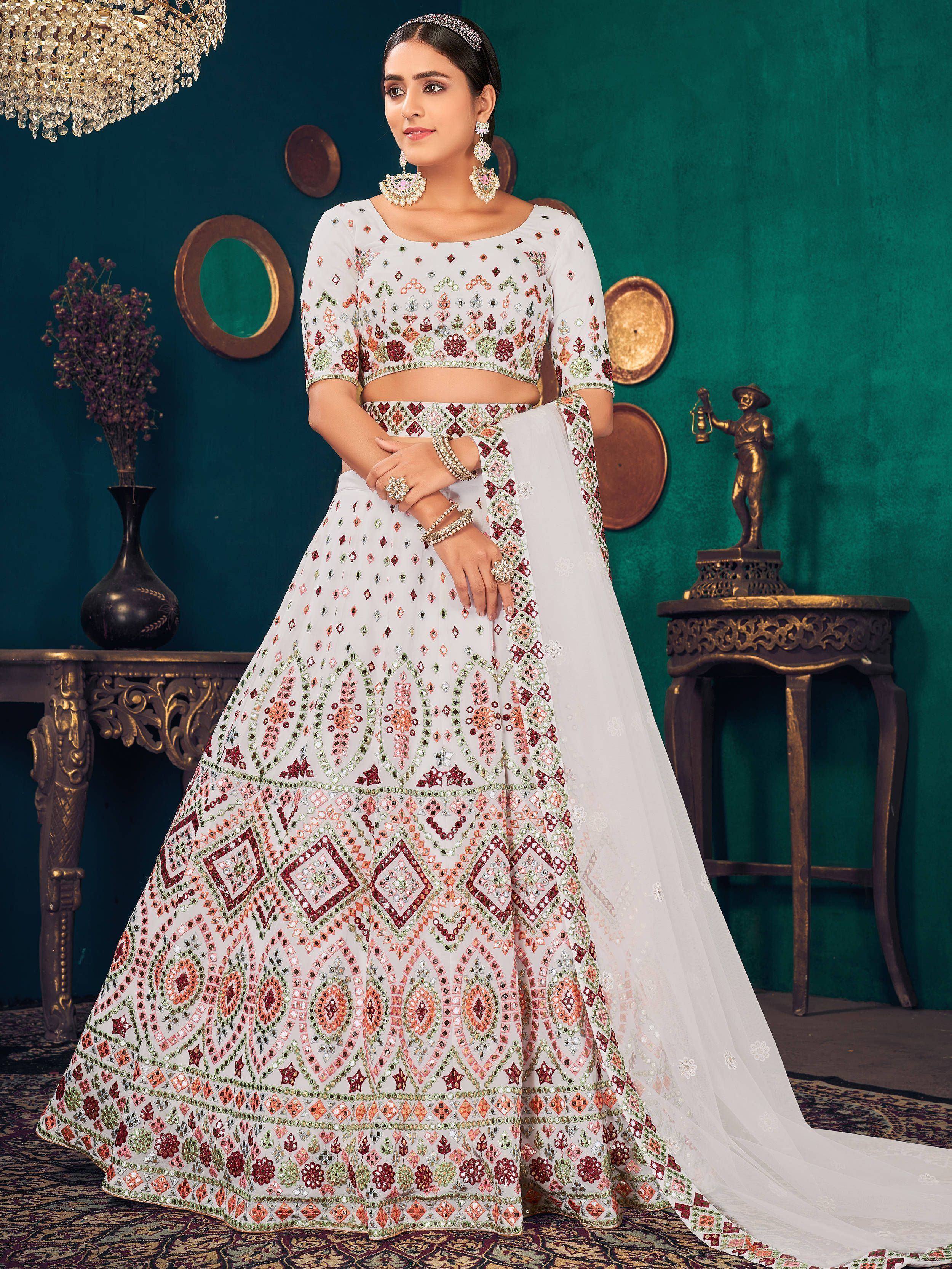 White embroidered lehenga choli with mirror work, perfect for Indian weddings and festive occasions.