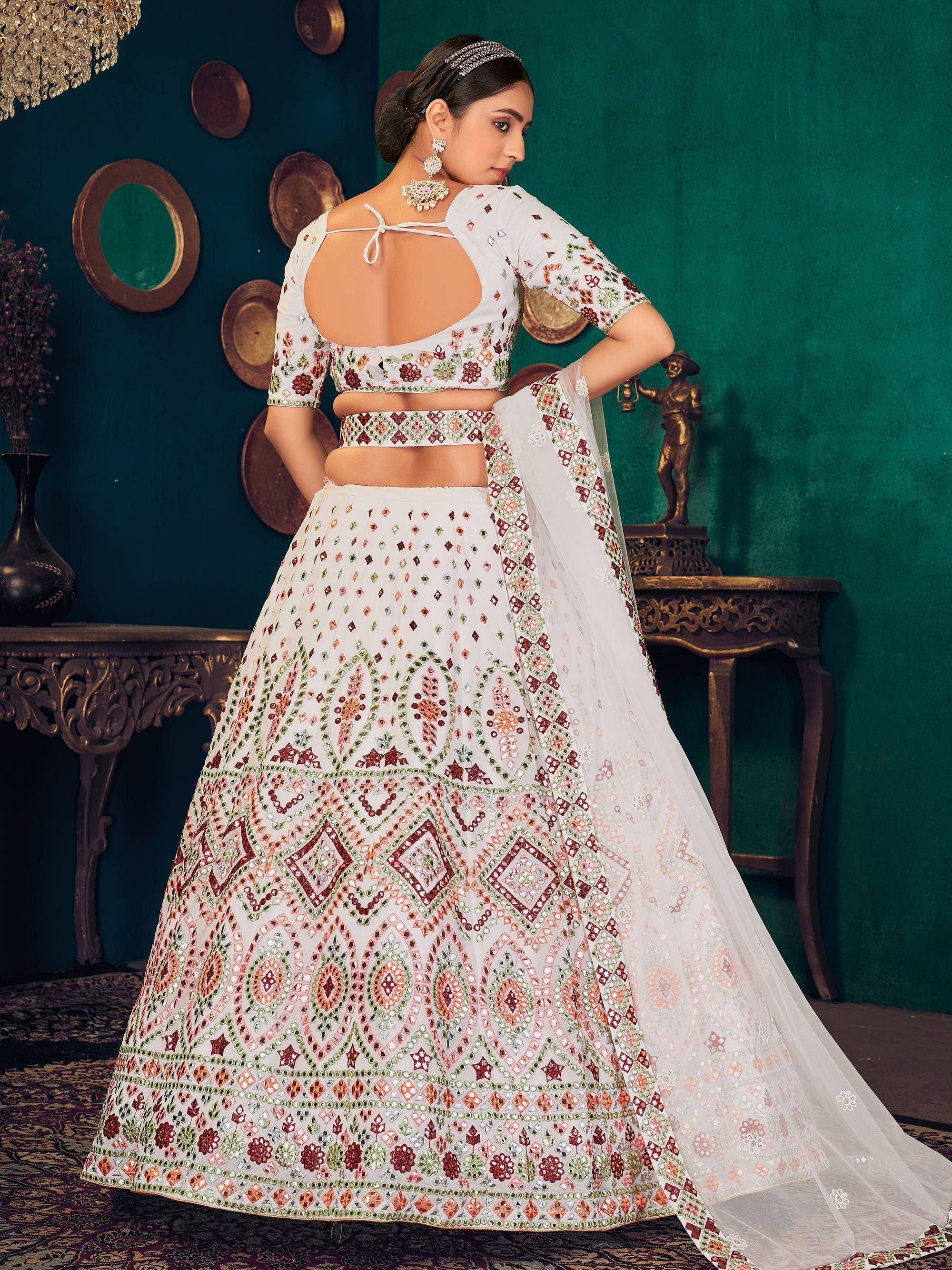 White embroidered lehenga choli with mirror work, perfect for Indian weddings and festive occasions