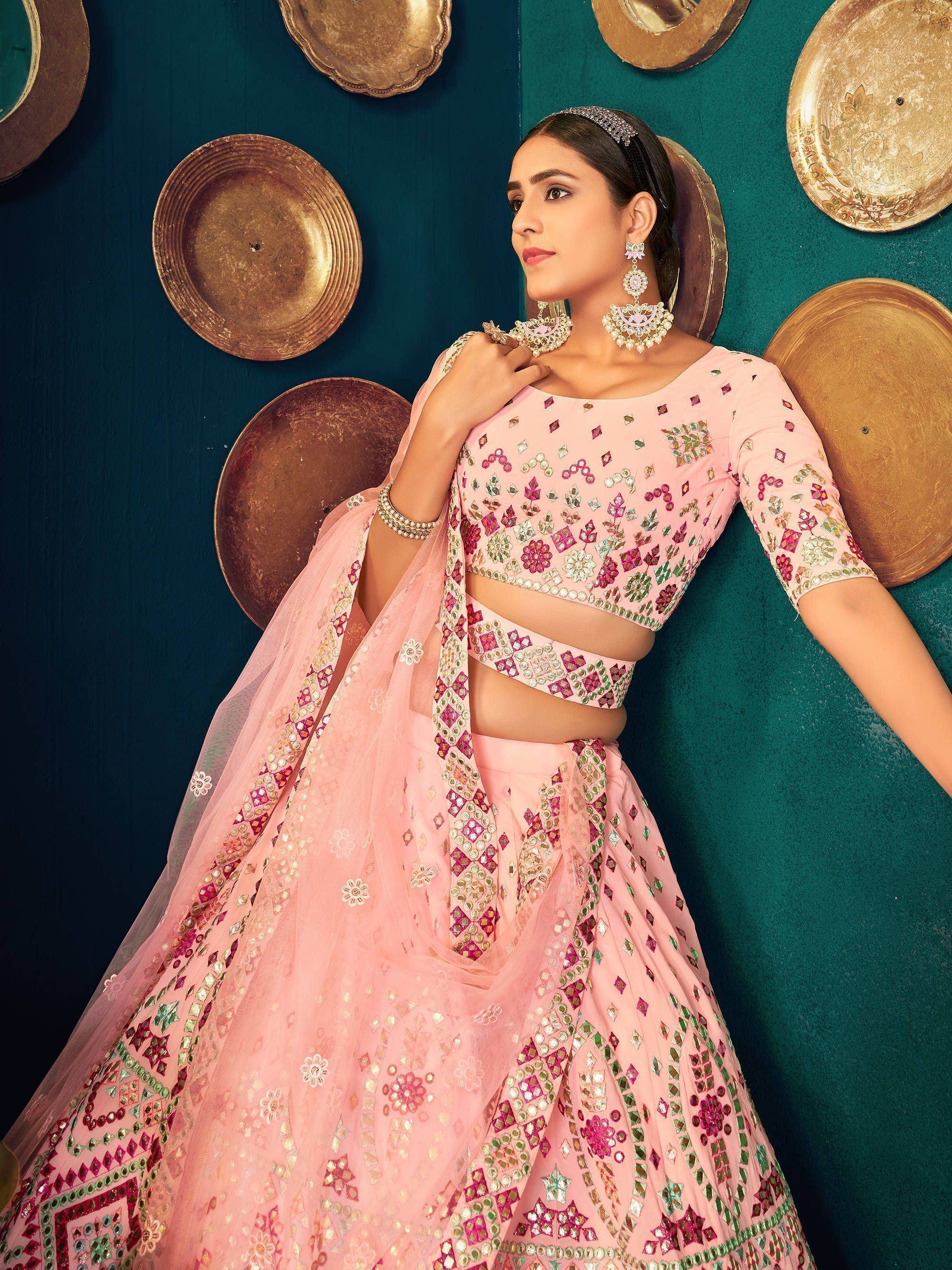 Pink designer lehenga choli with mirror work, floral embroidery, and dupatta, perfect for Indian weddings and festive occasions.