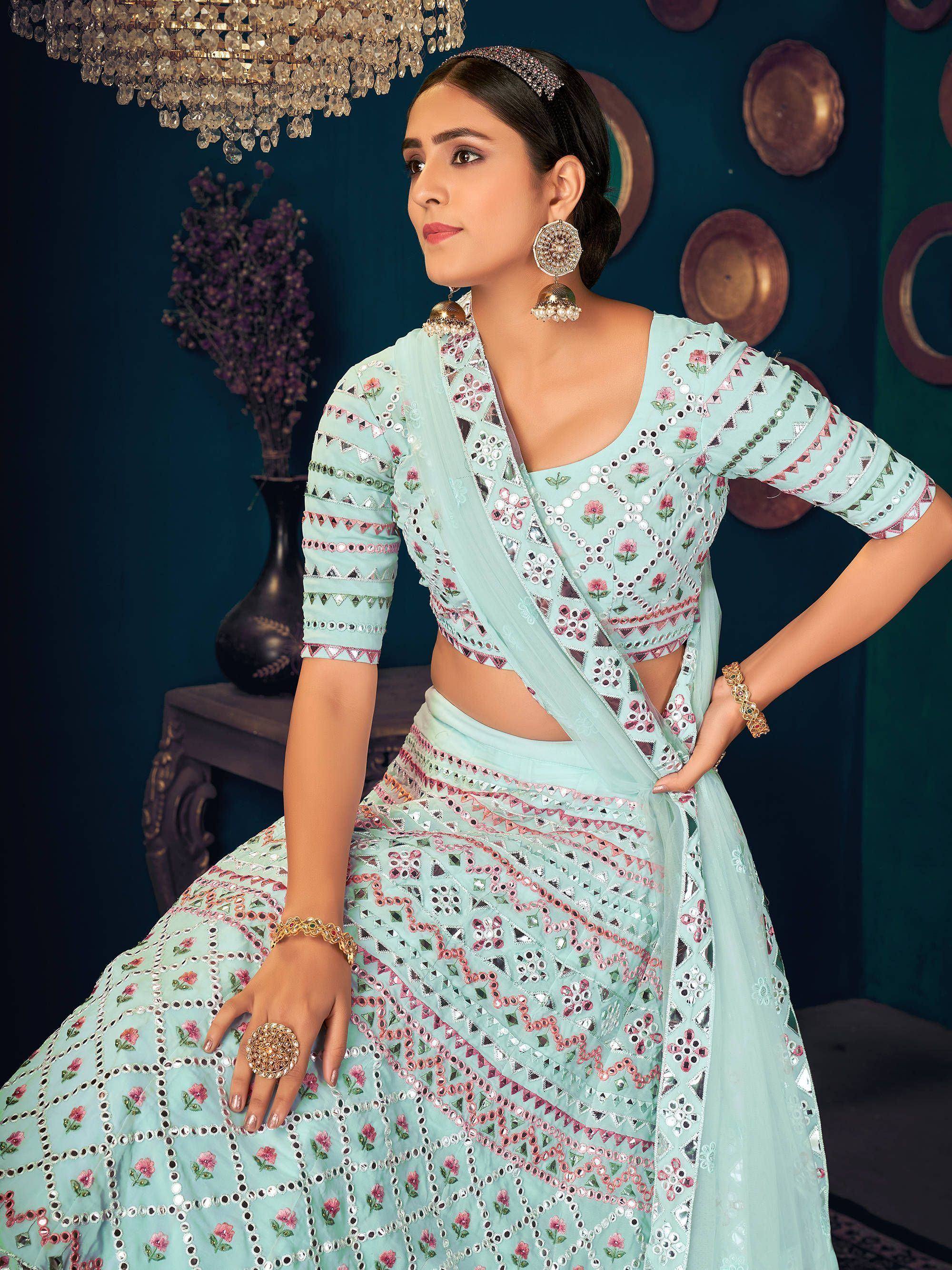 Mint green designer lehenga choli with mirror work and floral embroidery, perfect for Indian ethnic wear.