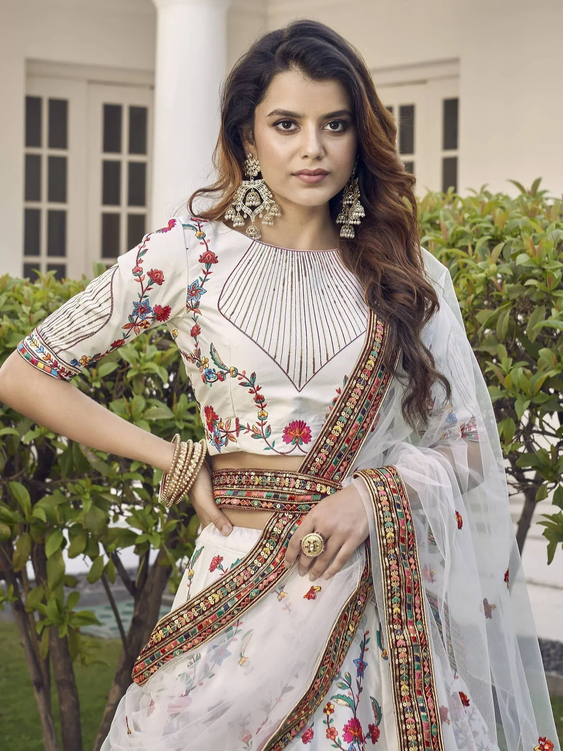 White embroidered lehenga choli with floral design and colorful border, perfect for Indian ethnic wear