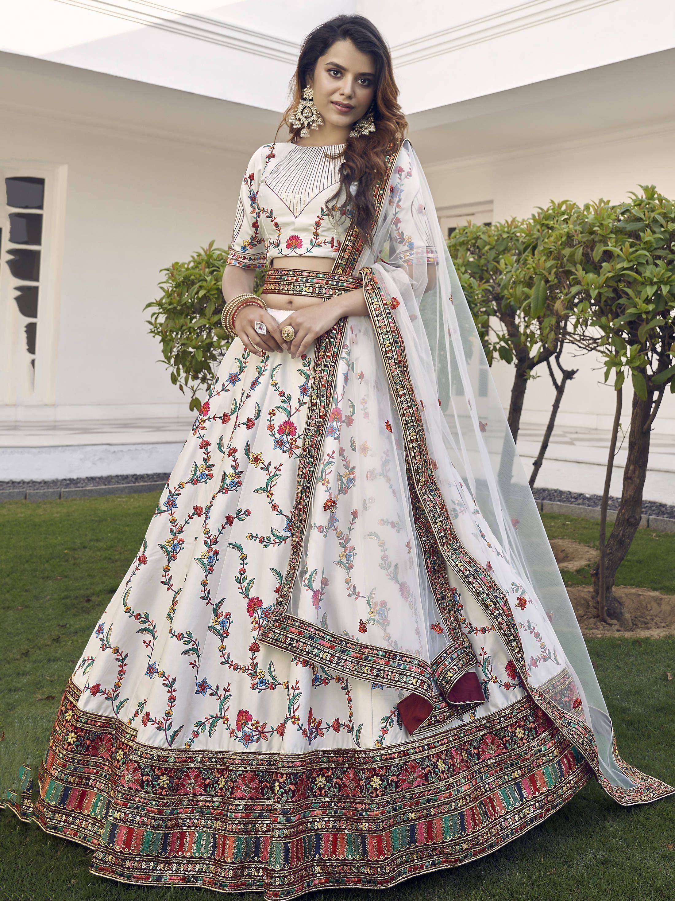 White floral embroidered lehenga choli with colorful border, perfect for Indian ethnic occasions
