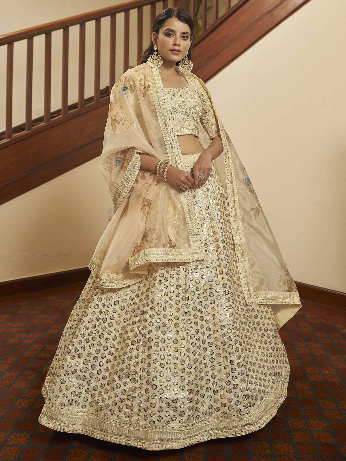 Elegant cream lehenga choli with gold floral embroidery and sequins, perfect for Indian weddings and festive occasions.