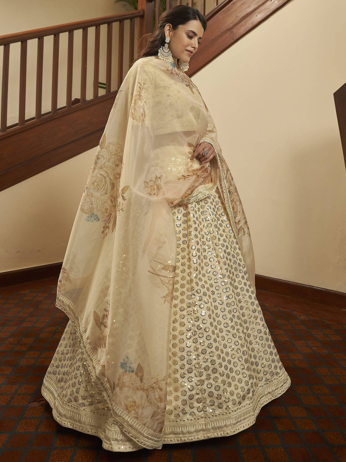 Cream floral lehenga choli with gold sequin work and sheer dupatta, perfect for Indian weddings and festive occasions.
