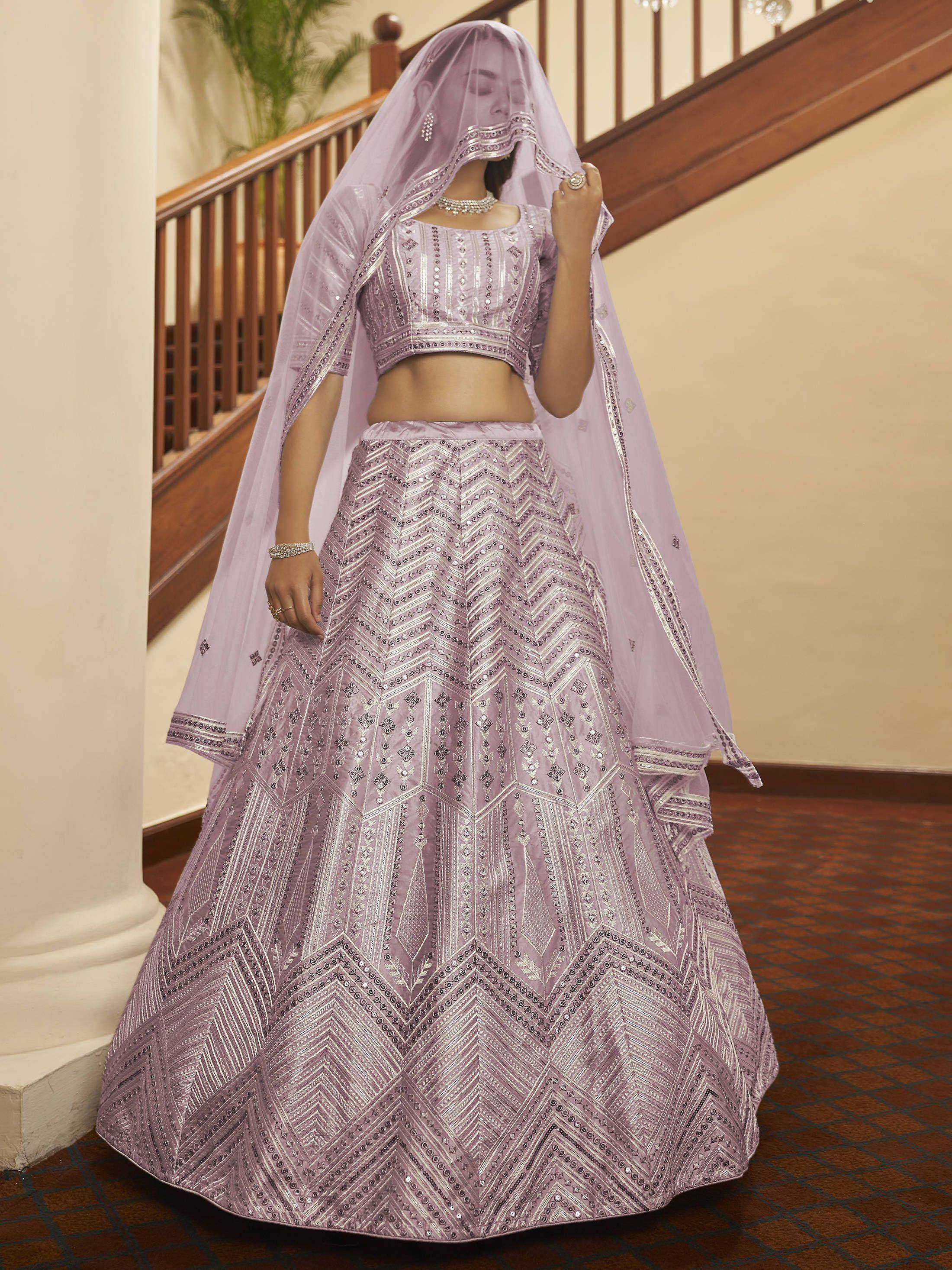 Lavender lehenga choli with intricate geometric embroidery and matching dupatta, perfect for Indian weddings and festive occasions.