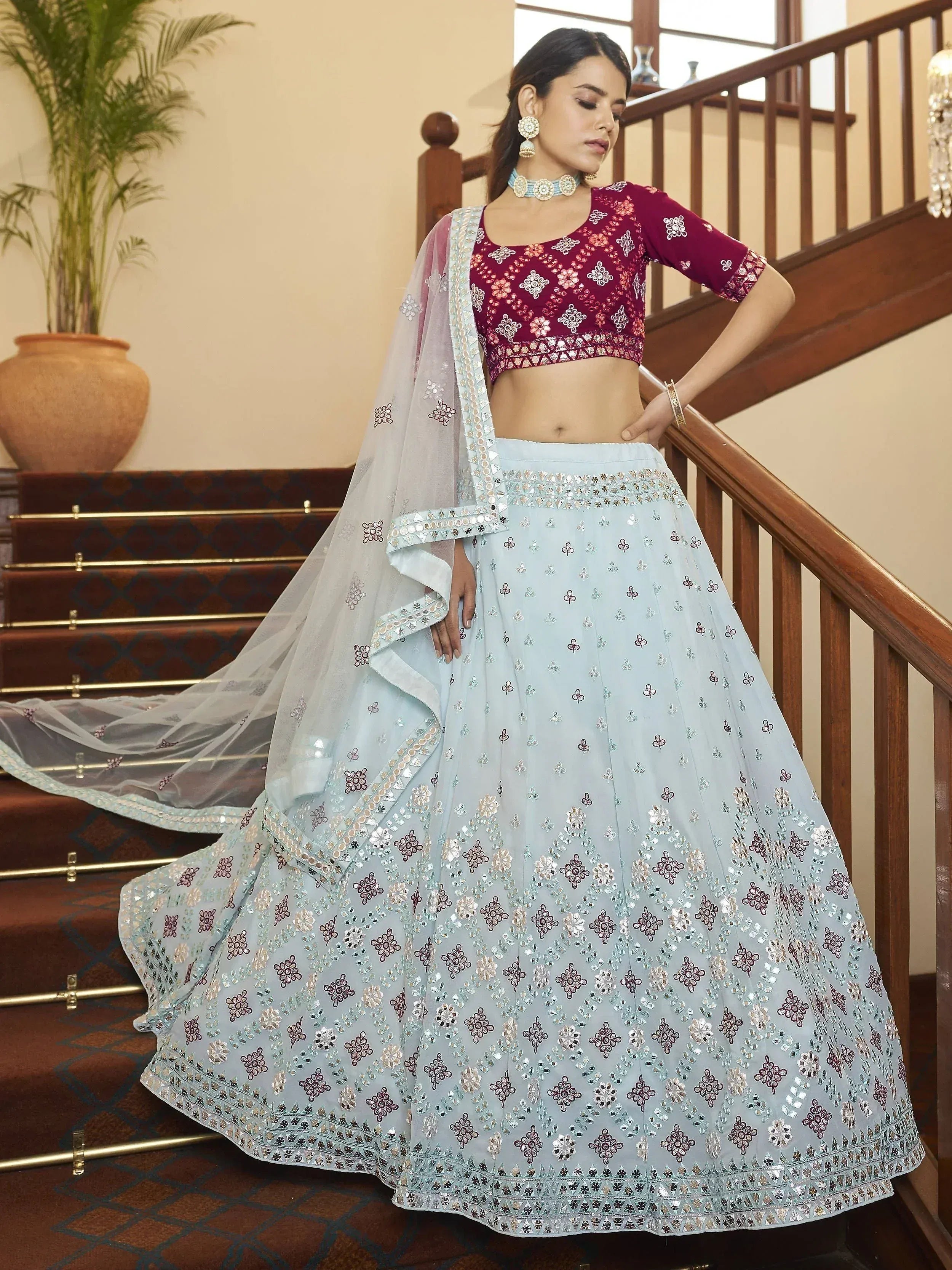 Light blue embroidered lehenga choli with maroon blouse, perfect for Indian weddings and festive occasions.