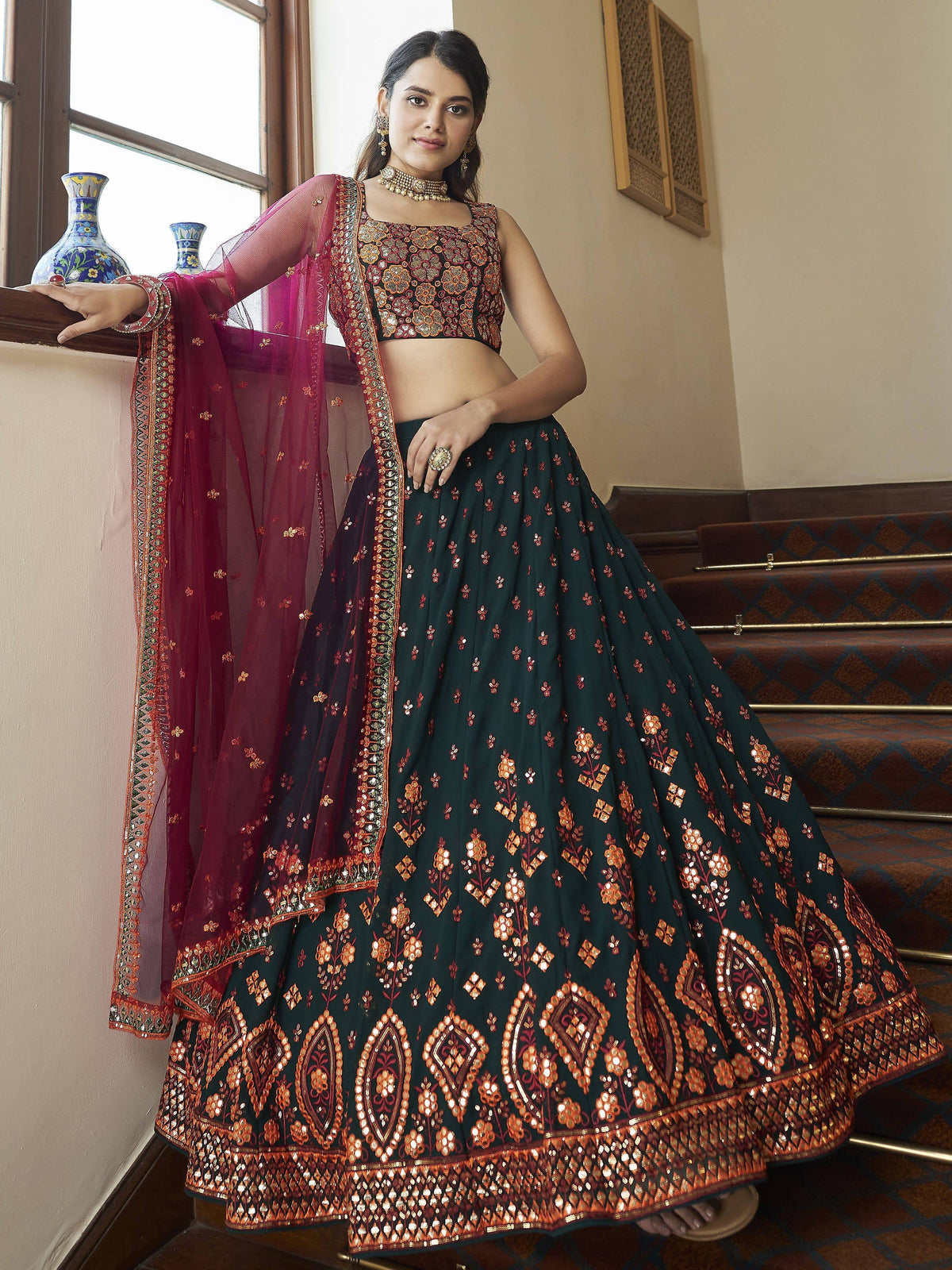 Elegant green lehenga choli with gold embroidery and maroon dupatta, perfect for Indian ethnic wear.