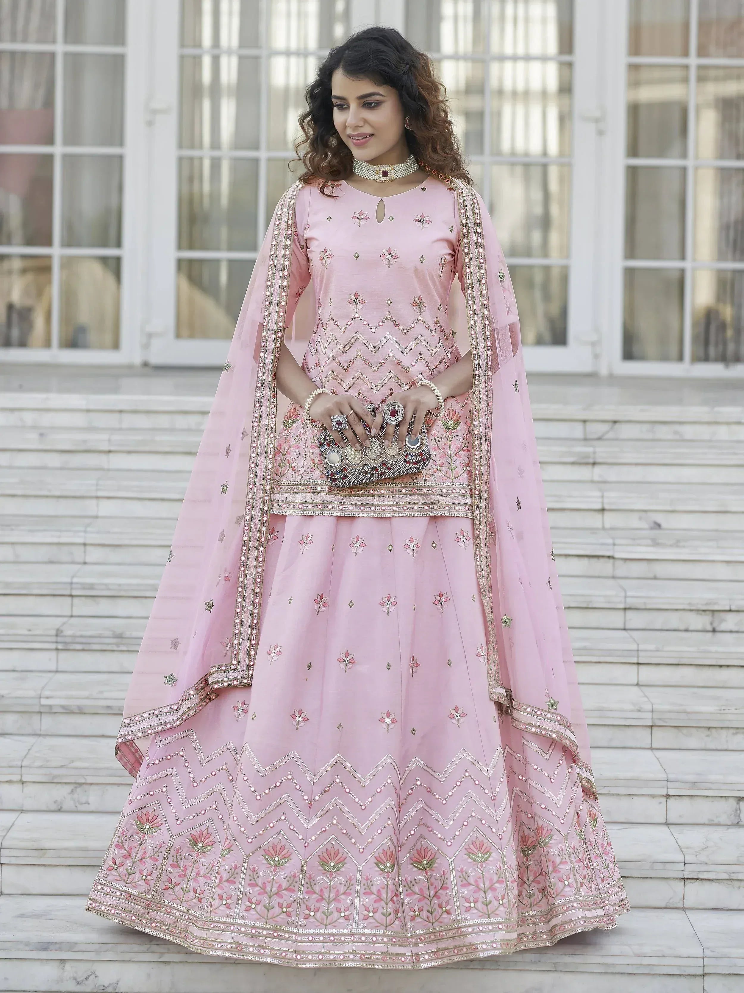Pink embroidered lehenga choli with floral and zigzag patterns, perfect for Indian ethnic occasions