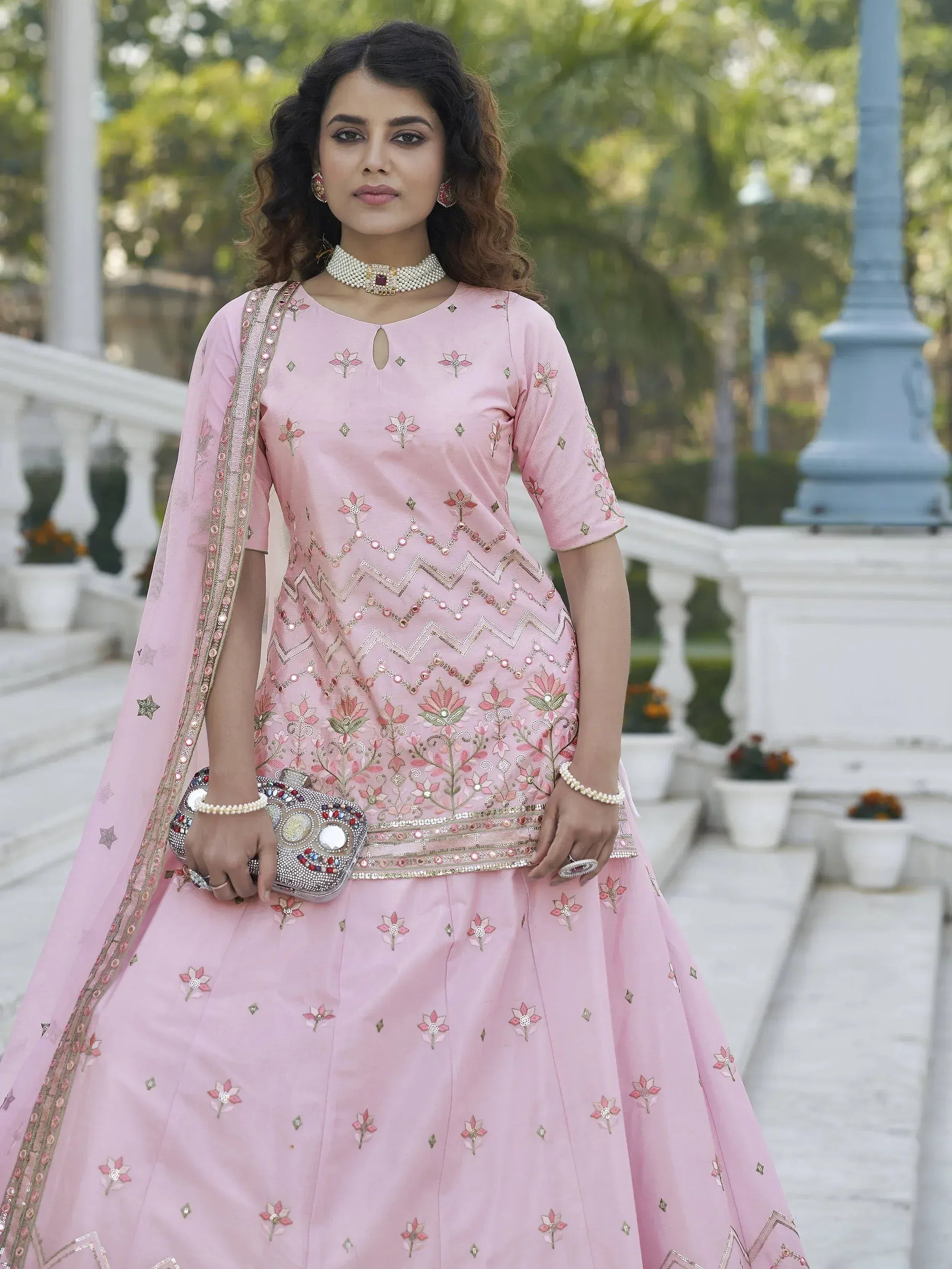 Pink embroidered designer lehenga choli with floral motifs and matching dupatta, perfect for Indian ethnic occasions.
