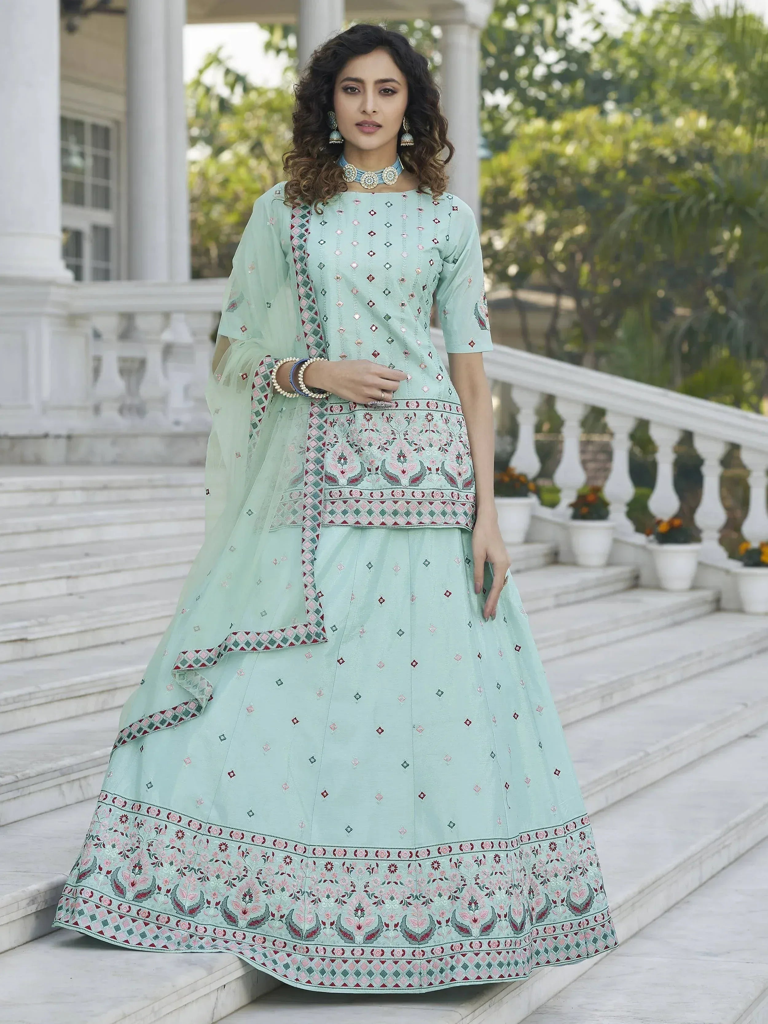 Mint green embroidered lehenga choli with floral motifs, perfect for Indian ethnic wear occasions.