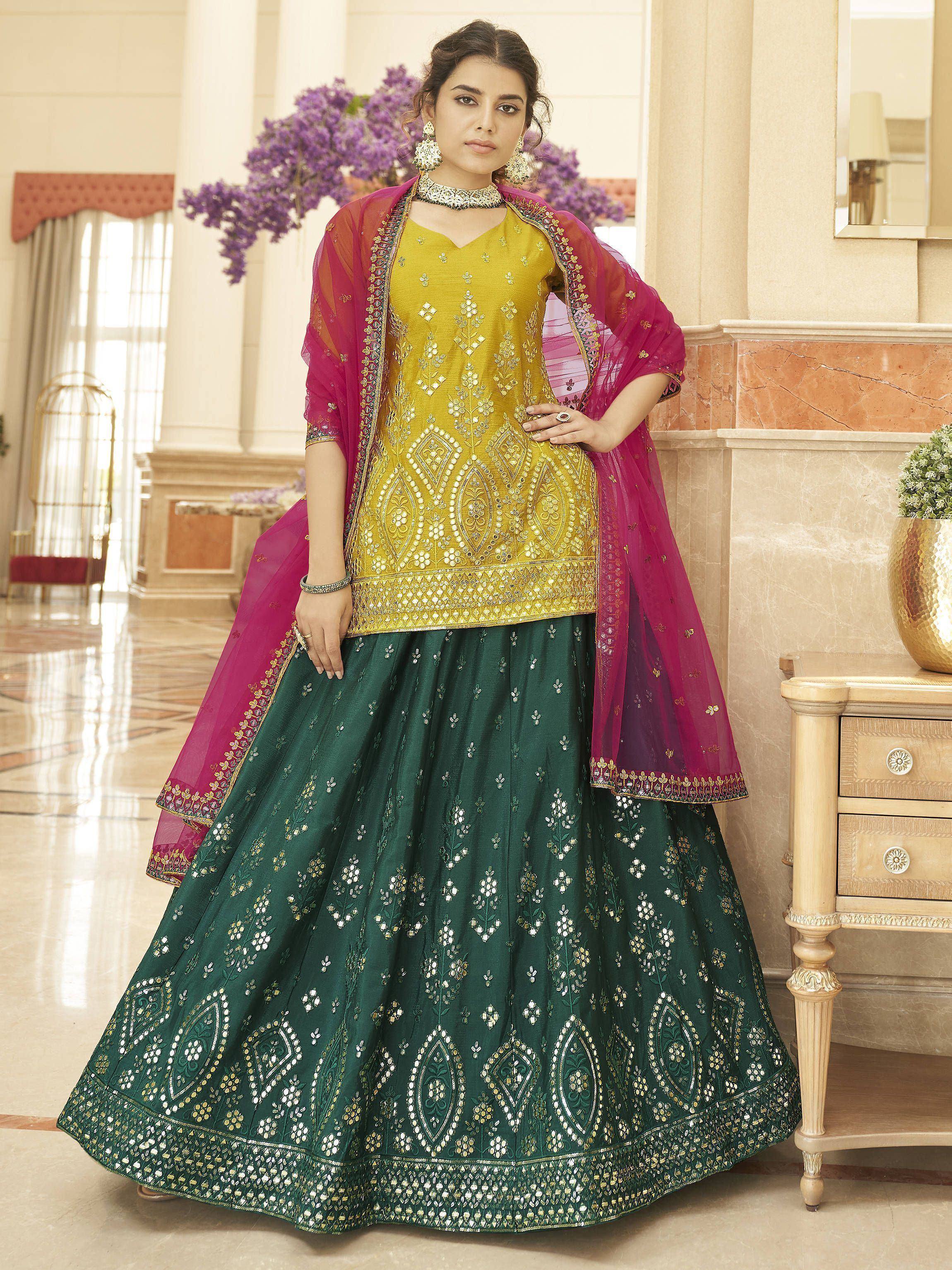Elegant green and gold embroidered lehenga choli with pink dupatta, perfect for Indian ethnic occasions
