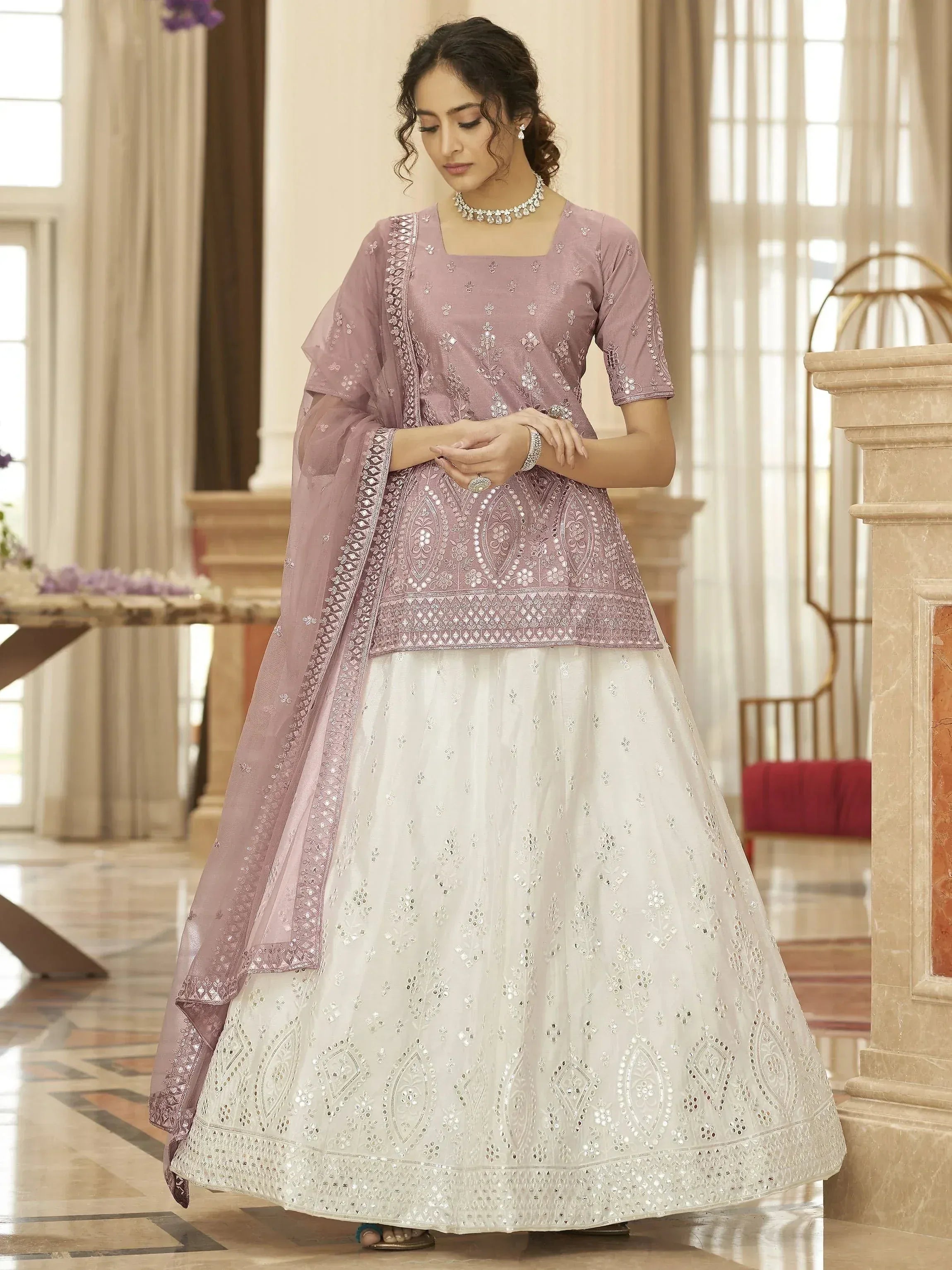 Elegant lavender and white embroidered lehenga choli with mirror work, perfect for Indian ethnic occasions.
