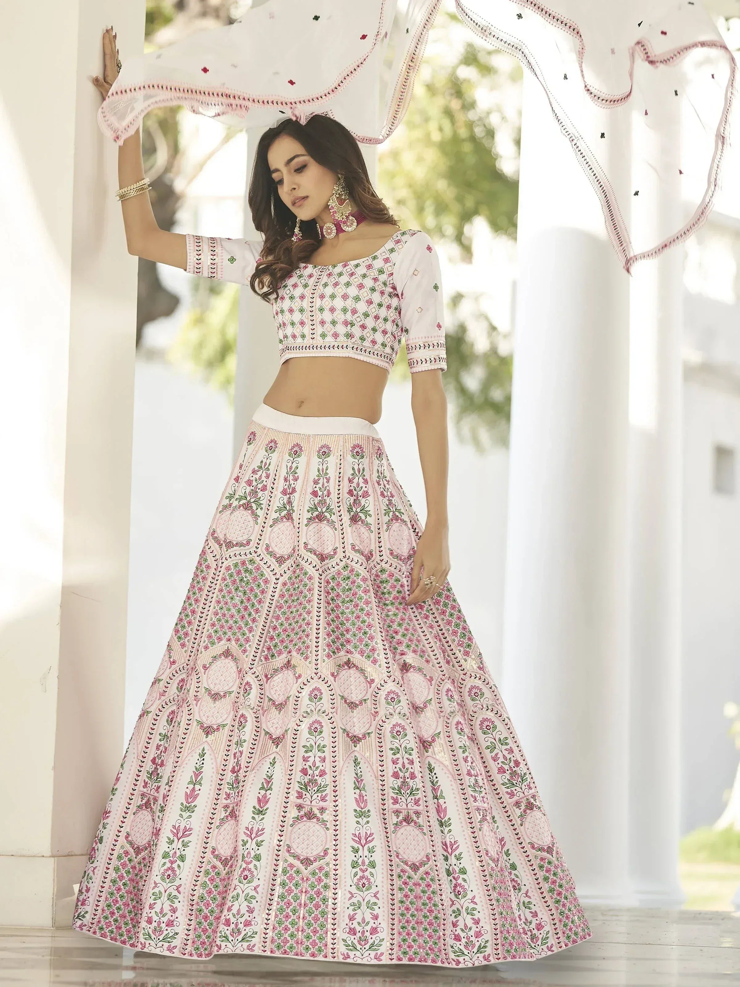 White and pink embroidered lehenga choli with floral patterns, perfect for Indian ethnic wear occasions