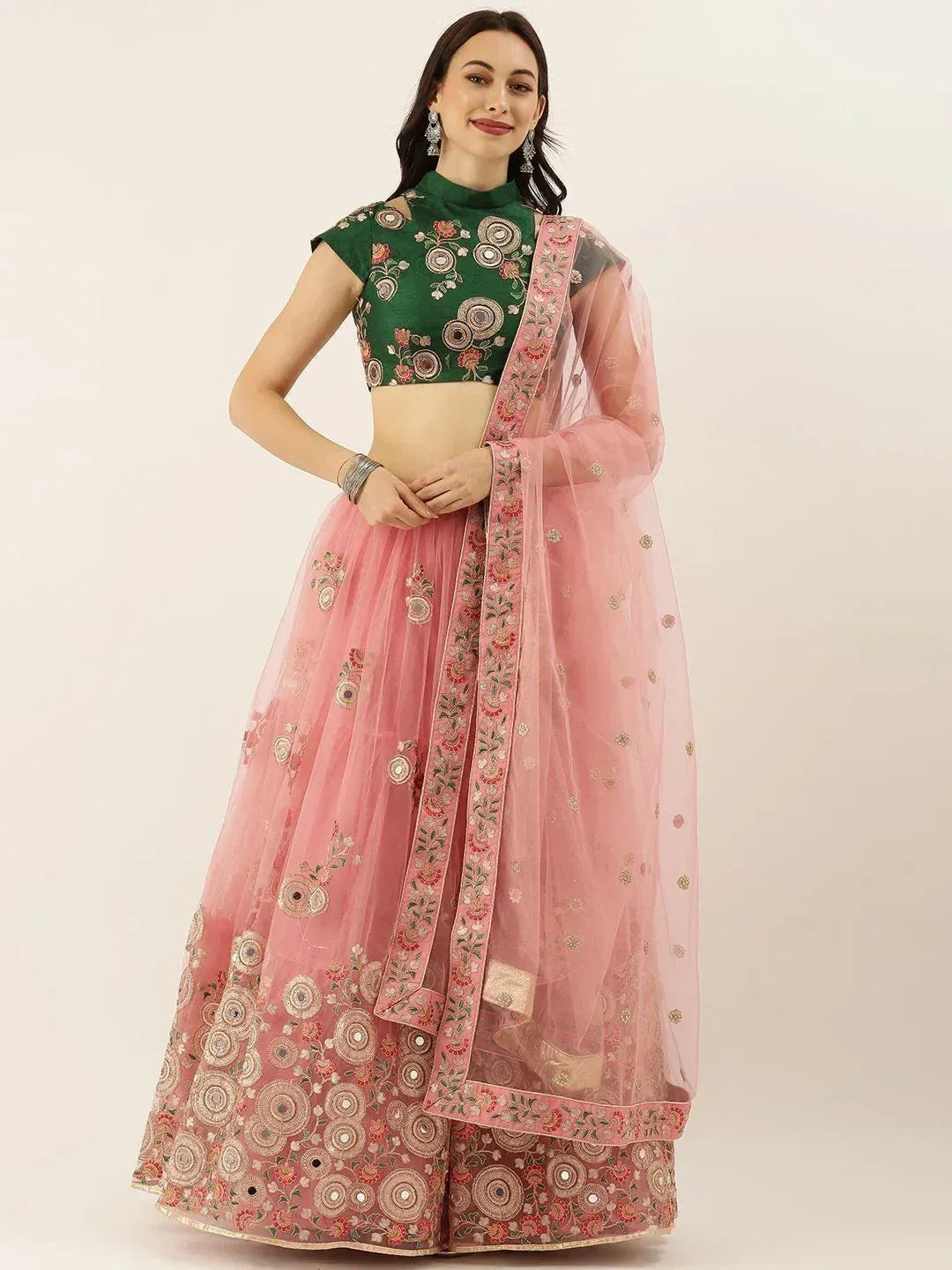 Pink embroidered lehenga choli with green floral blouse, perfect for Indian weddings and festive occasions