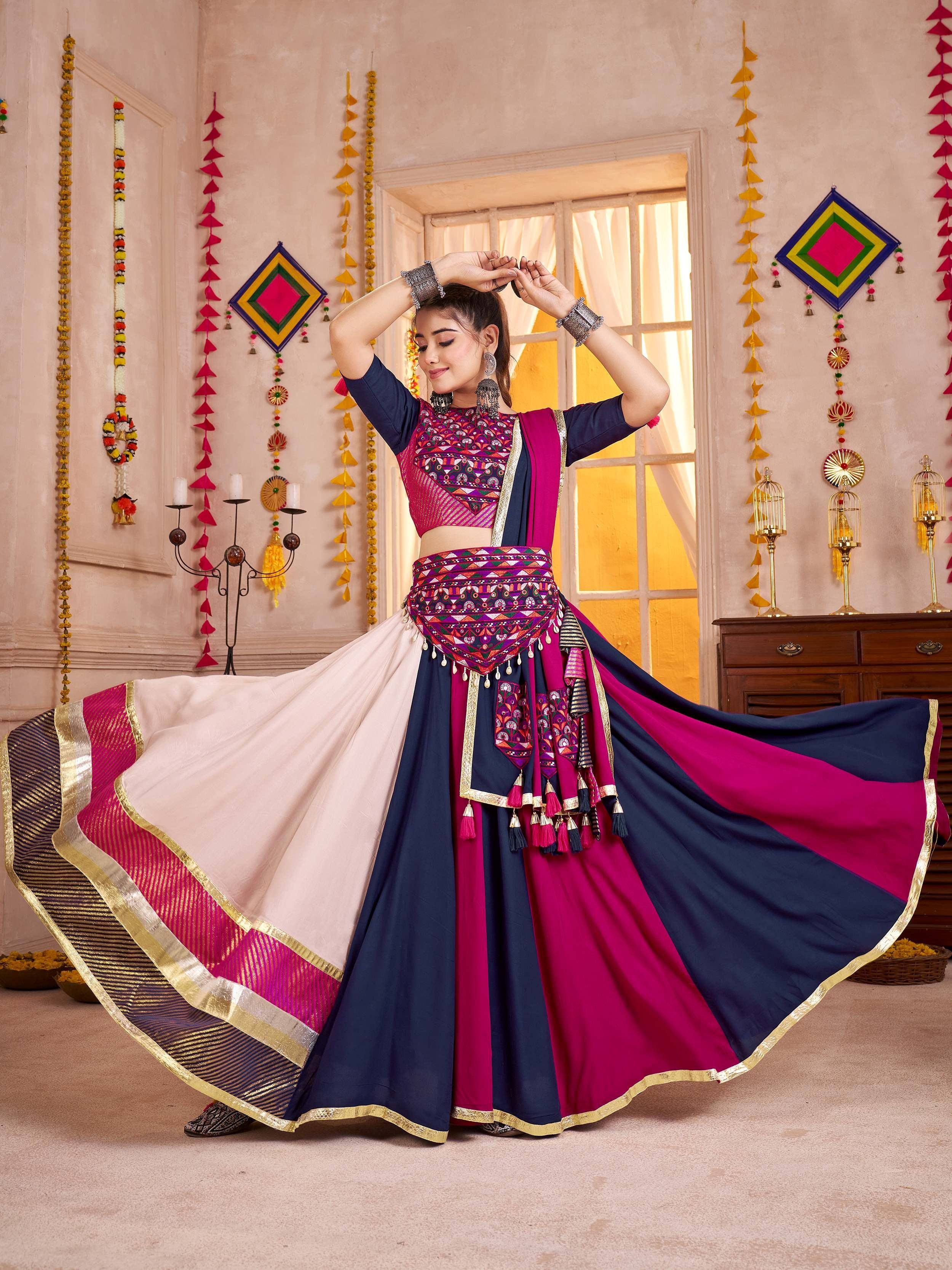 Woman in vibrant Indian ethnic lehenga choli with mirror work, perfect for festive occasions and celebrations.