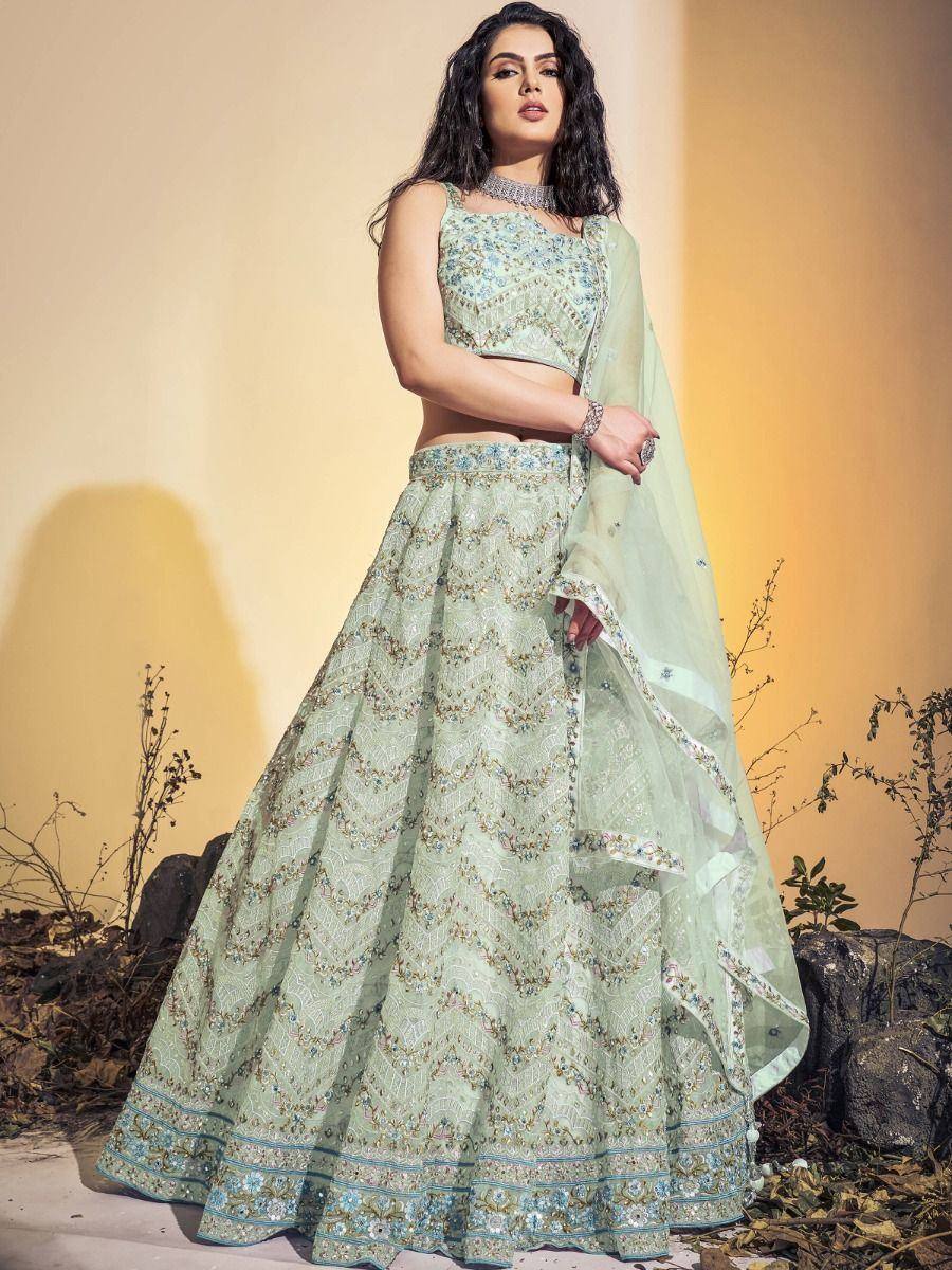 Mint green designer lehenga choli with intricate embroidery and matching dupatta, perfect for Indian ethnic occasions.