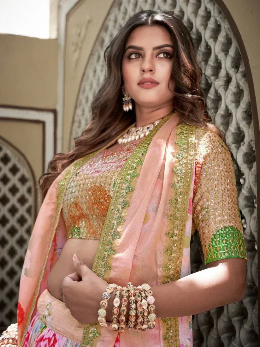 Woman in designer lehenga choli with sequin embroidery, floral dupatta, and traditional jewelry