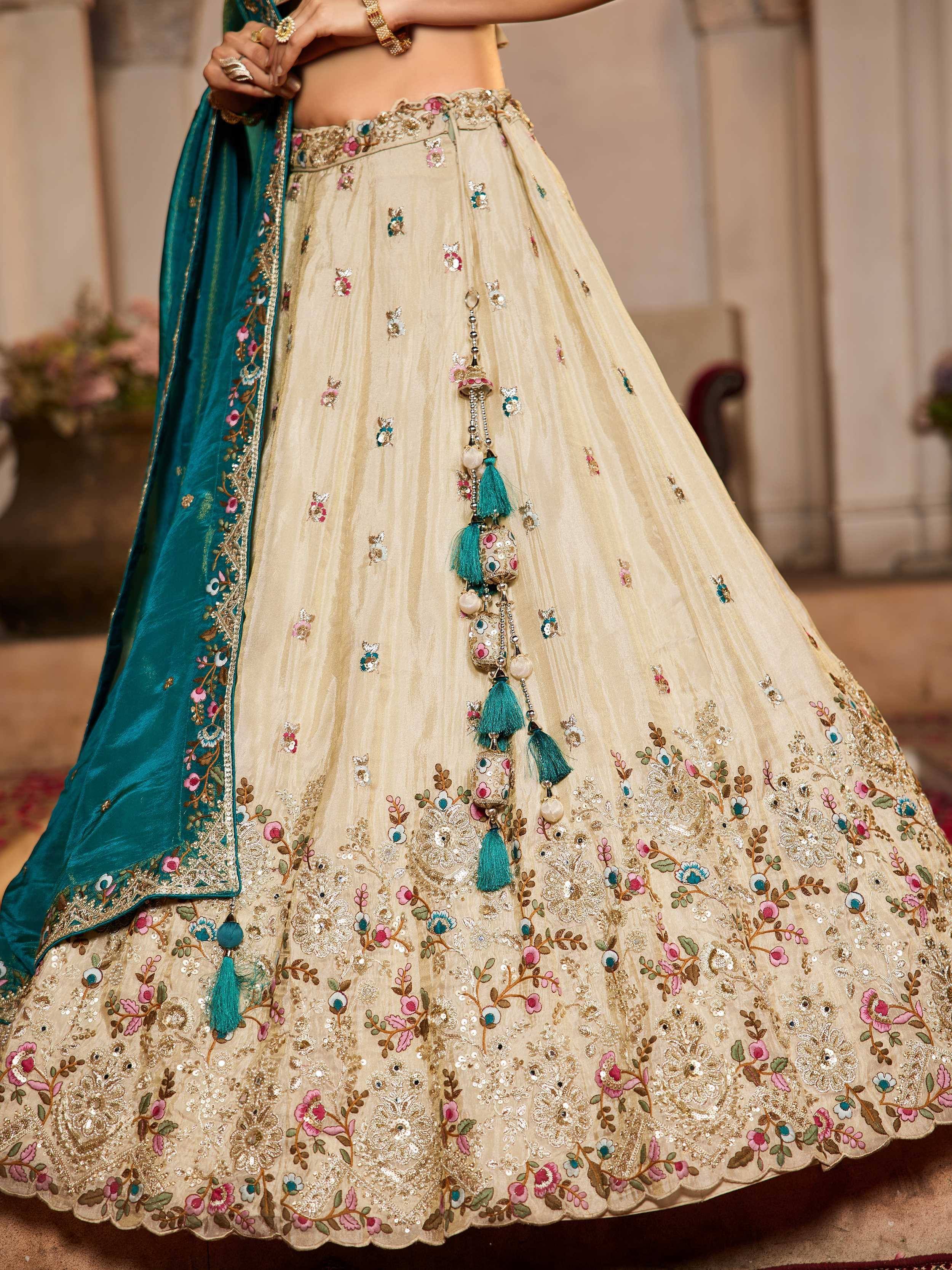 Beige floral embroidered lehenga with teal dupatta, perfect for Indian weddings and ethnic events.