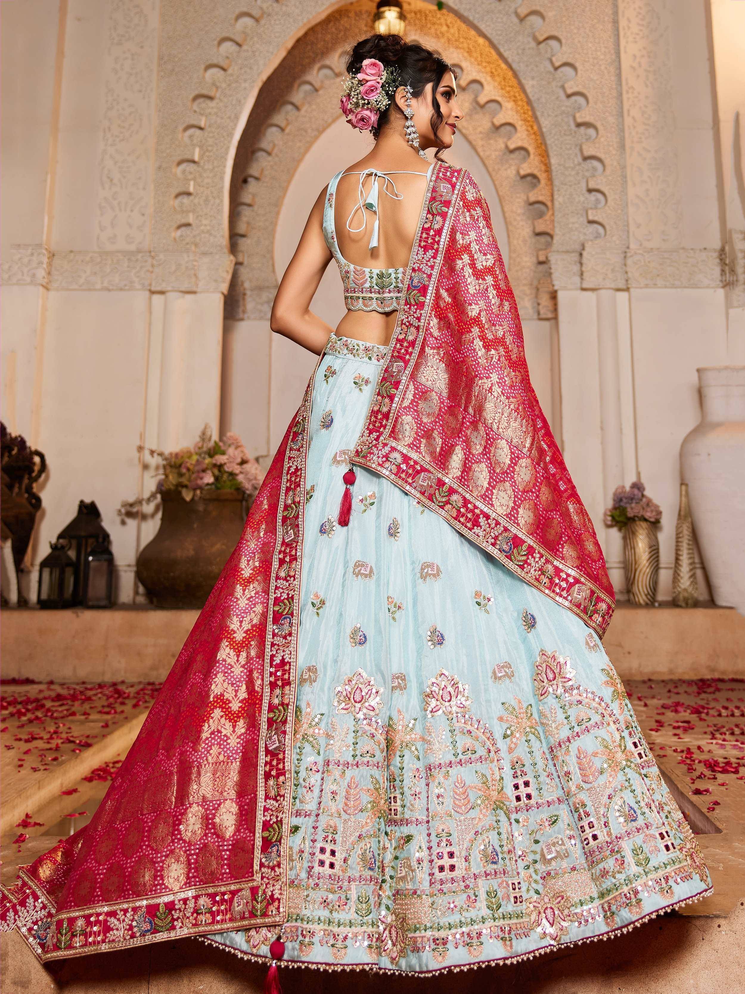 Light blue embroidered lehenga choli with red dupatta, floral motifs, and back tie blouse for Indian ethnic wear