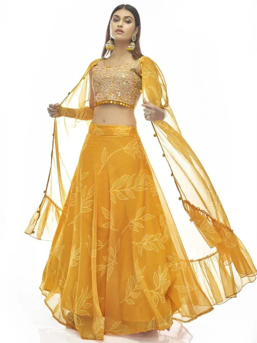 Yellow embroidered lehenga choli with leaf print and sheer dupatta, perfect for Indian ethnic wear occasions