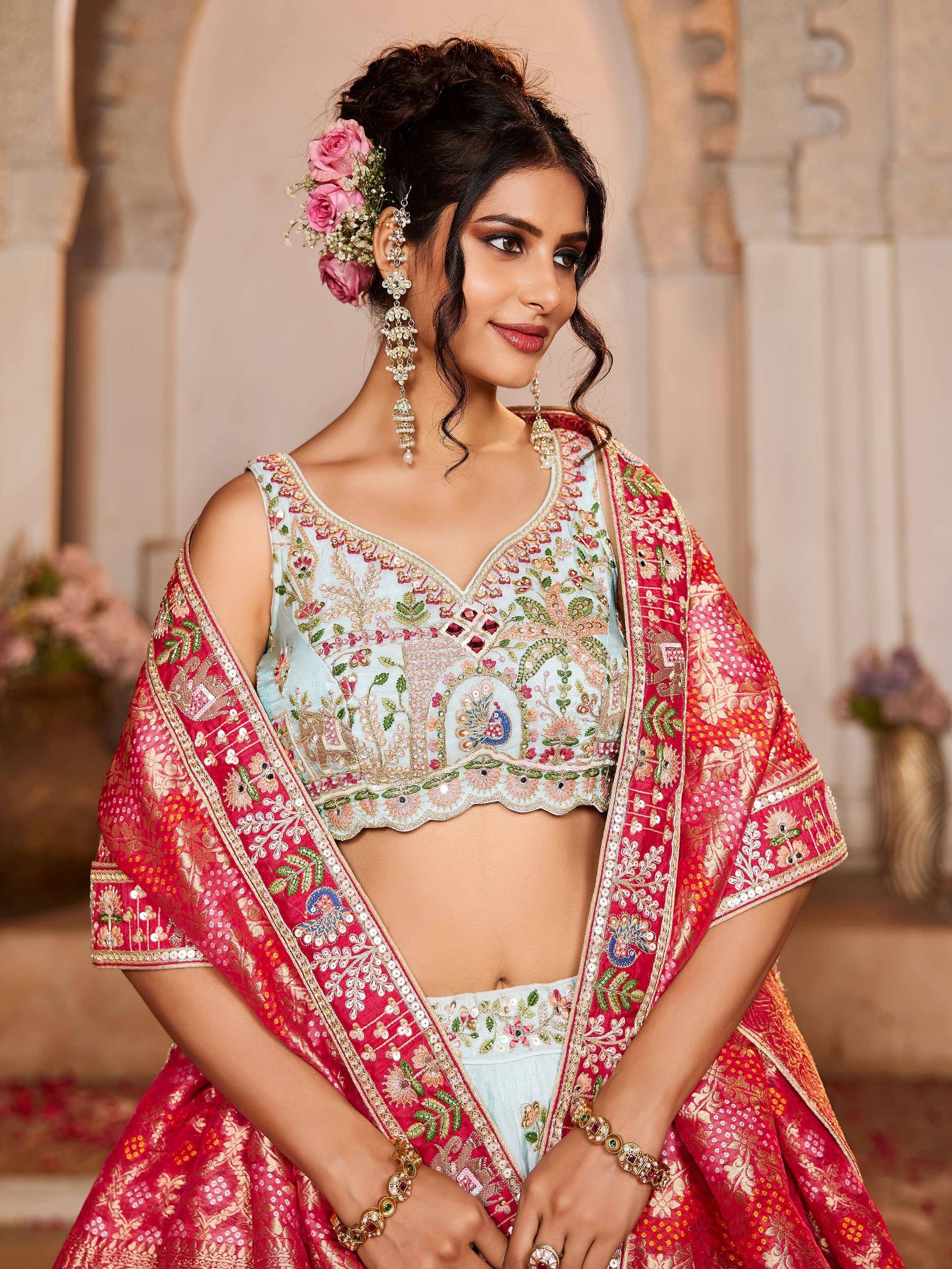 Elegant Indian bridal lehenga choli with intricate floral embroidery, peacock motifs, and vibrant red dupatta for wedding celebrations